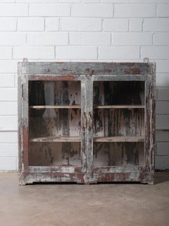 Rustic Indian Glass-Front Cabinet With Distressed Paint