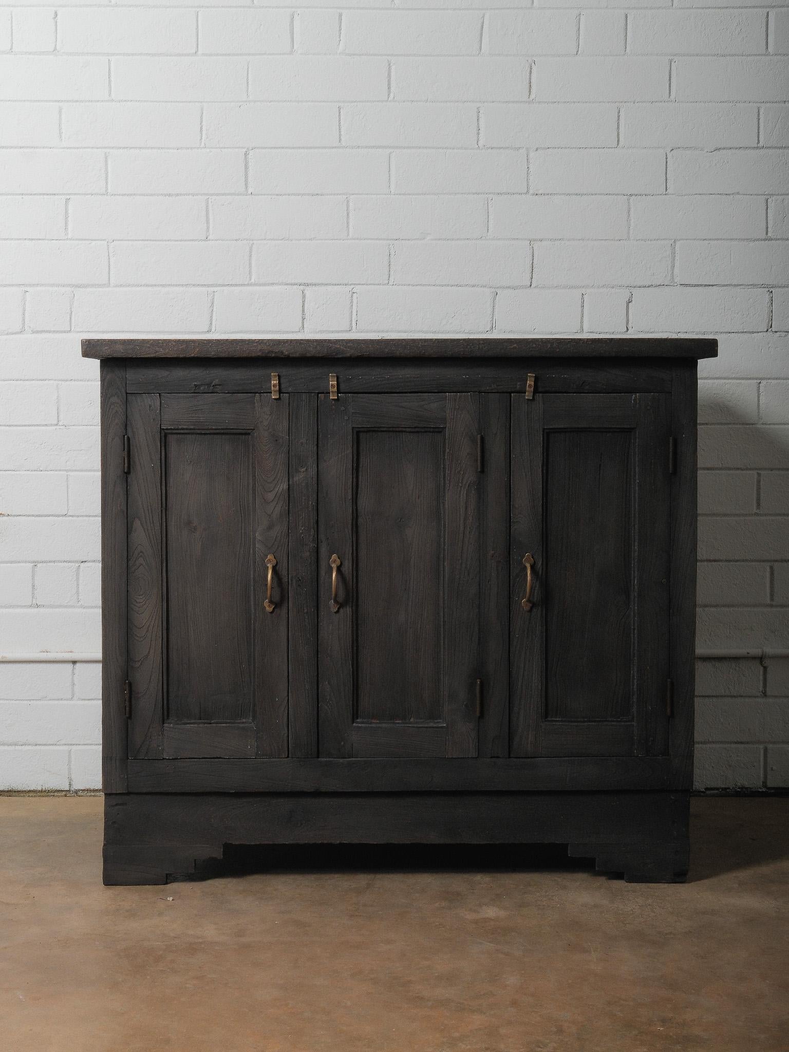 This hand-crafted charred wood sideboard features a beautifully aged surface and deep, smoky finish that highlights the natural grain and character of the reclaimed timber. This cabinet was built using traditional joinery and simple hand-forged