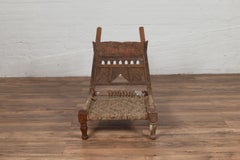 Rustic Indian Low Wooden Chair with Rope Seat and Weathered Appearance
