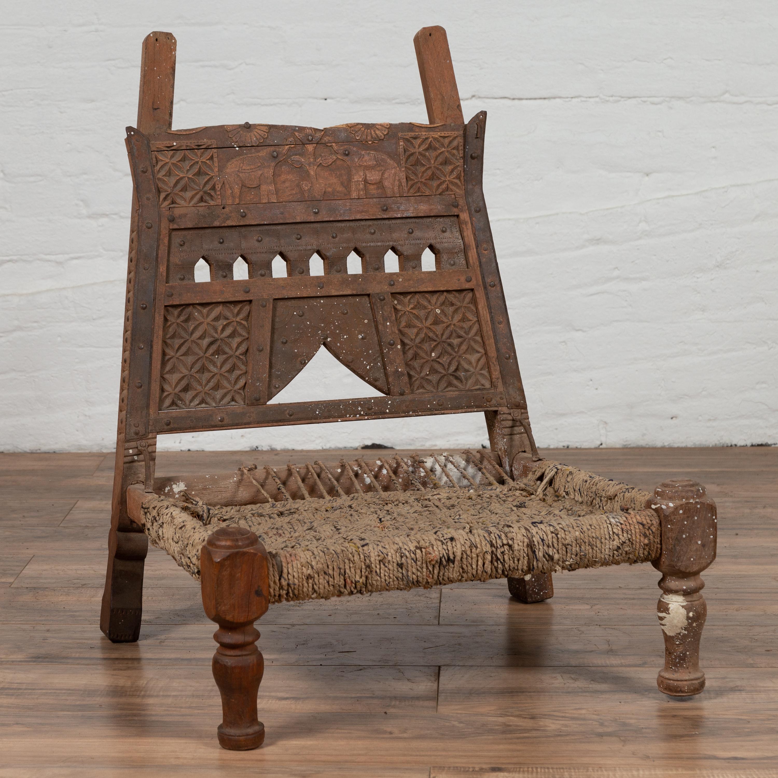 Rustic Indian Low Wooden Chair with Rope Seat and Weathered Appearance In Distressed Condition For Sale In Yonkers, NY