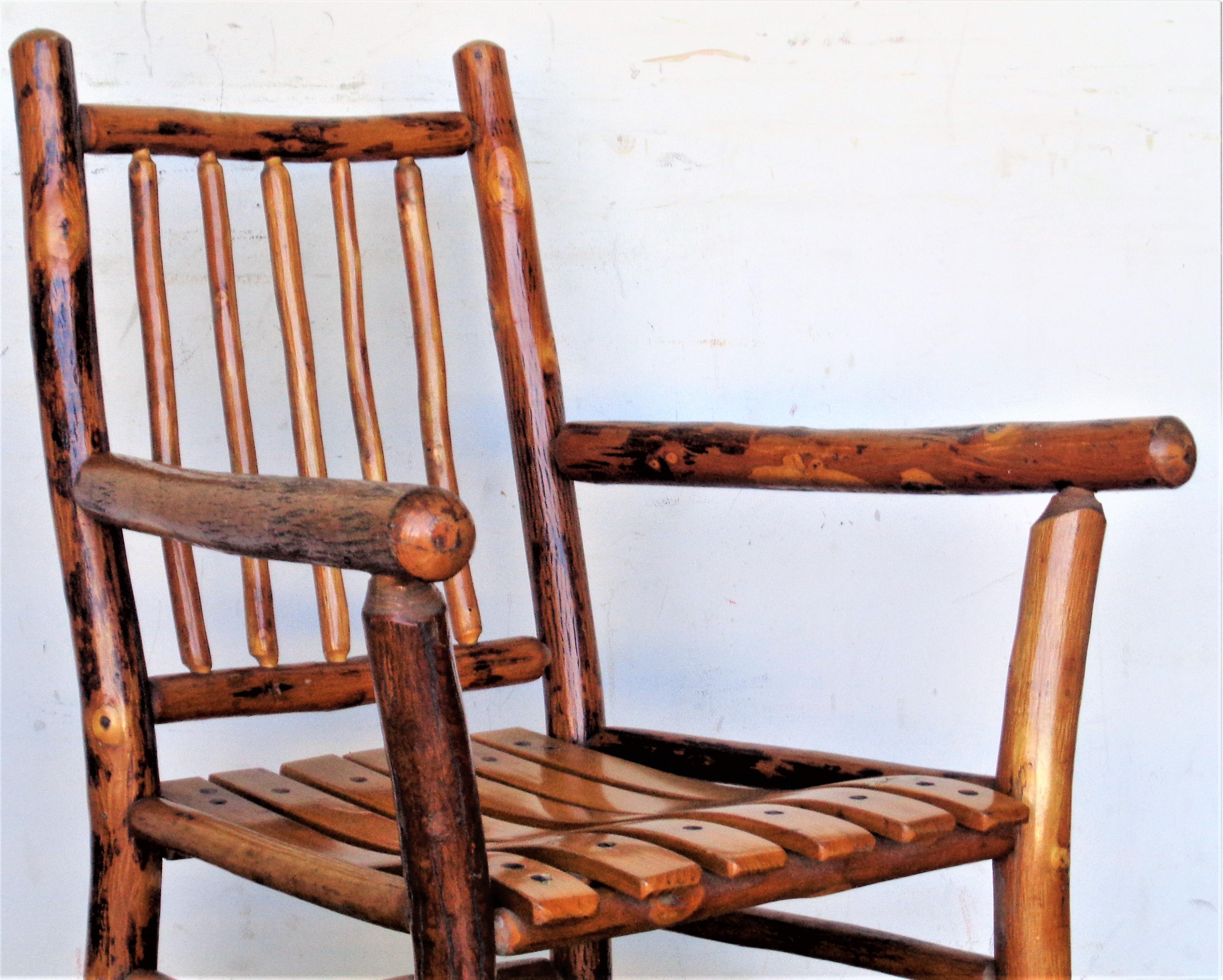 Rustic Old Hickory armchair in exceptional all original vintage condition with beautiful glowing rich honey colored surface. Burn mark stamped on underside of contoured wood slat seat - Old Hickory Martinsville Indiana. Circa 1930 - 1940. Look at