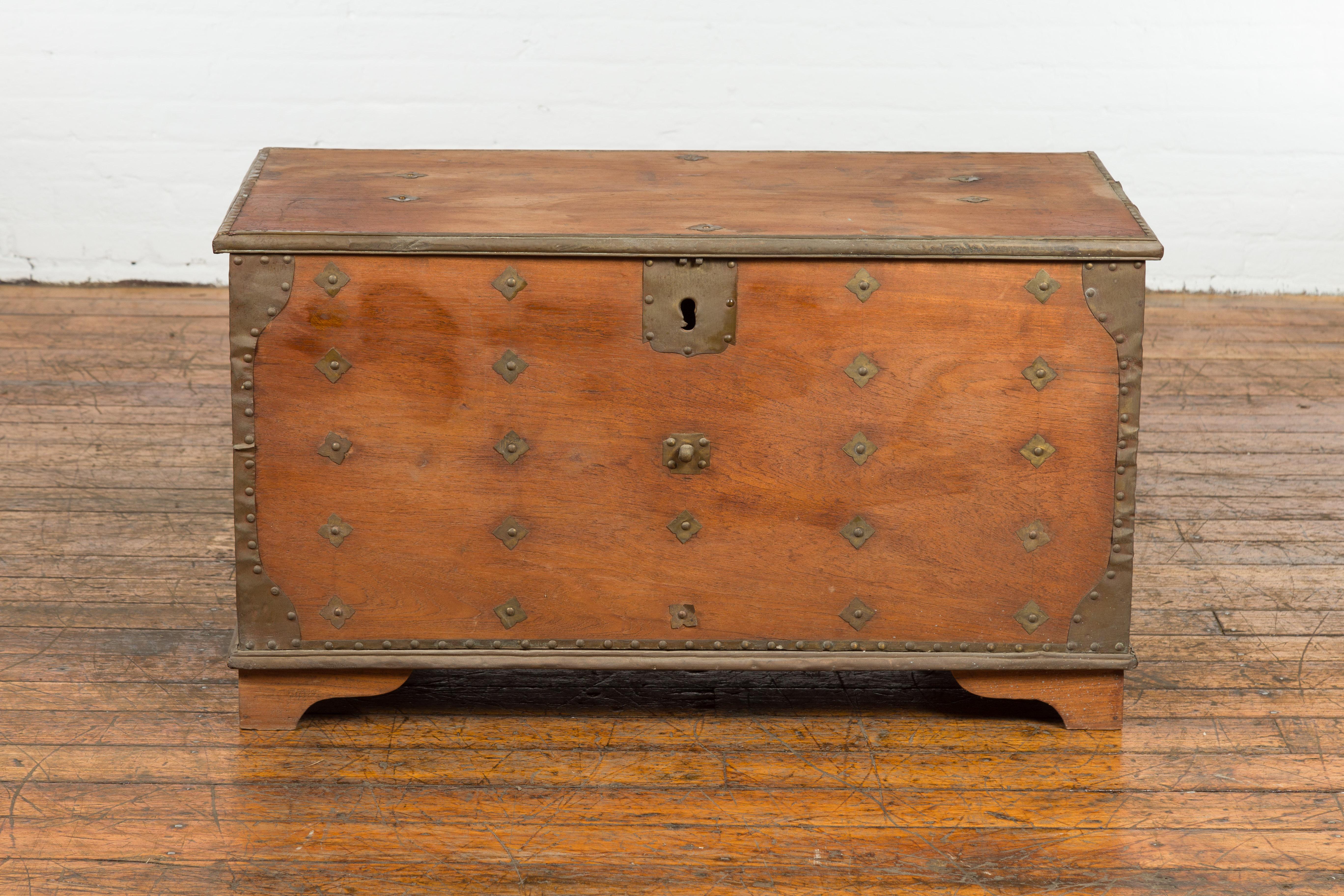 An Indonesian rustic blanket chest from the 19th century, with brass details and hidden storage box. Created in Indonesia during the 19th century, this blanket chest captures the attention with its brass accentuation and great rustic character. The
