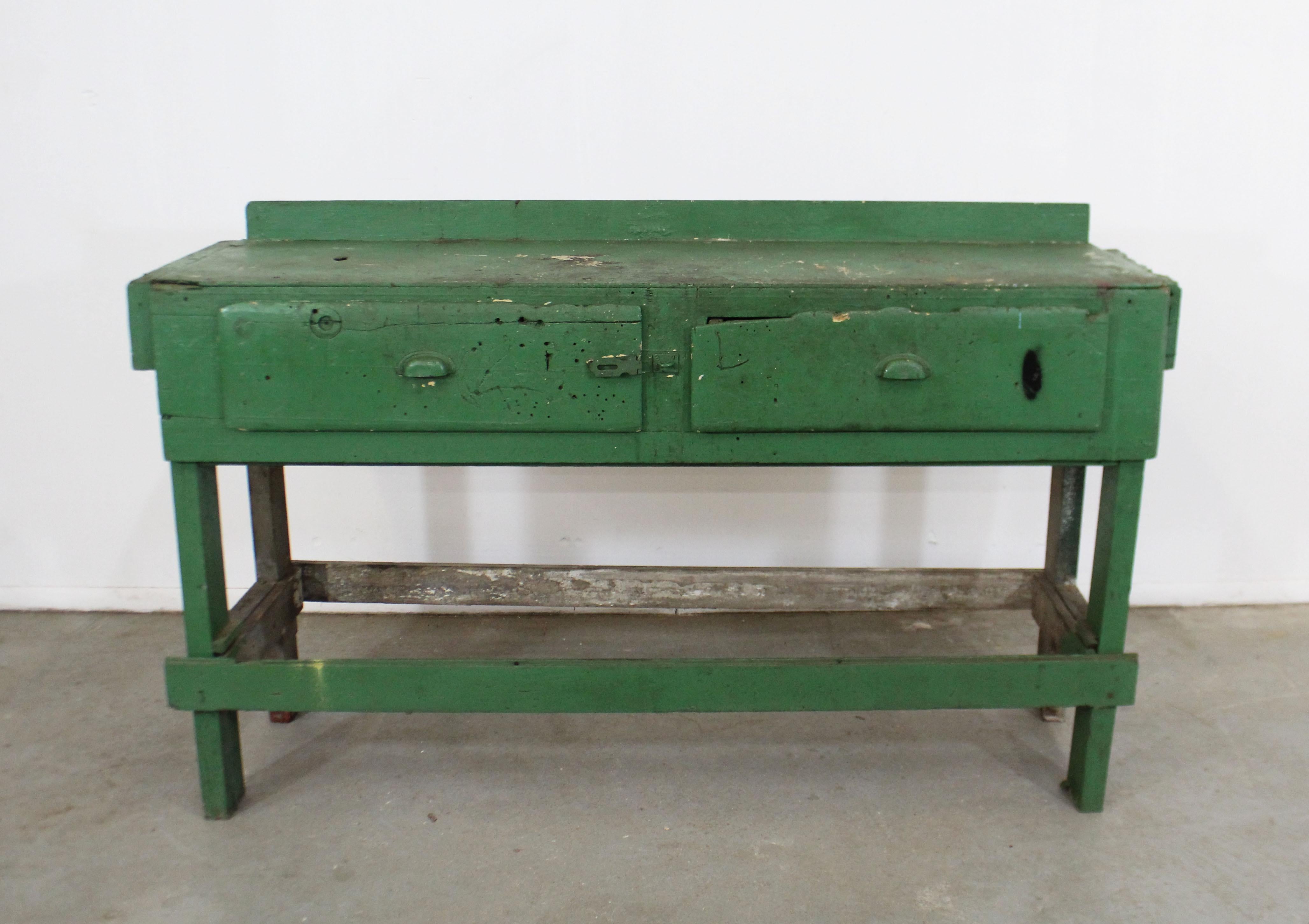 Offered is vintage/antique industrial/rustic style workbench, circa 1930s. Has two drawers with painted metal pulls, some miscellaneous hardware. This piece has a rustic look with obvious signs of age wear throughout (stains, chips, scratches,