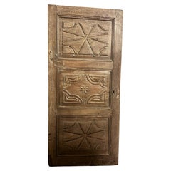 Antique Rustic interior door in carved walnut, smooth back, Italy