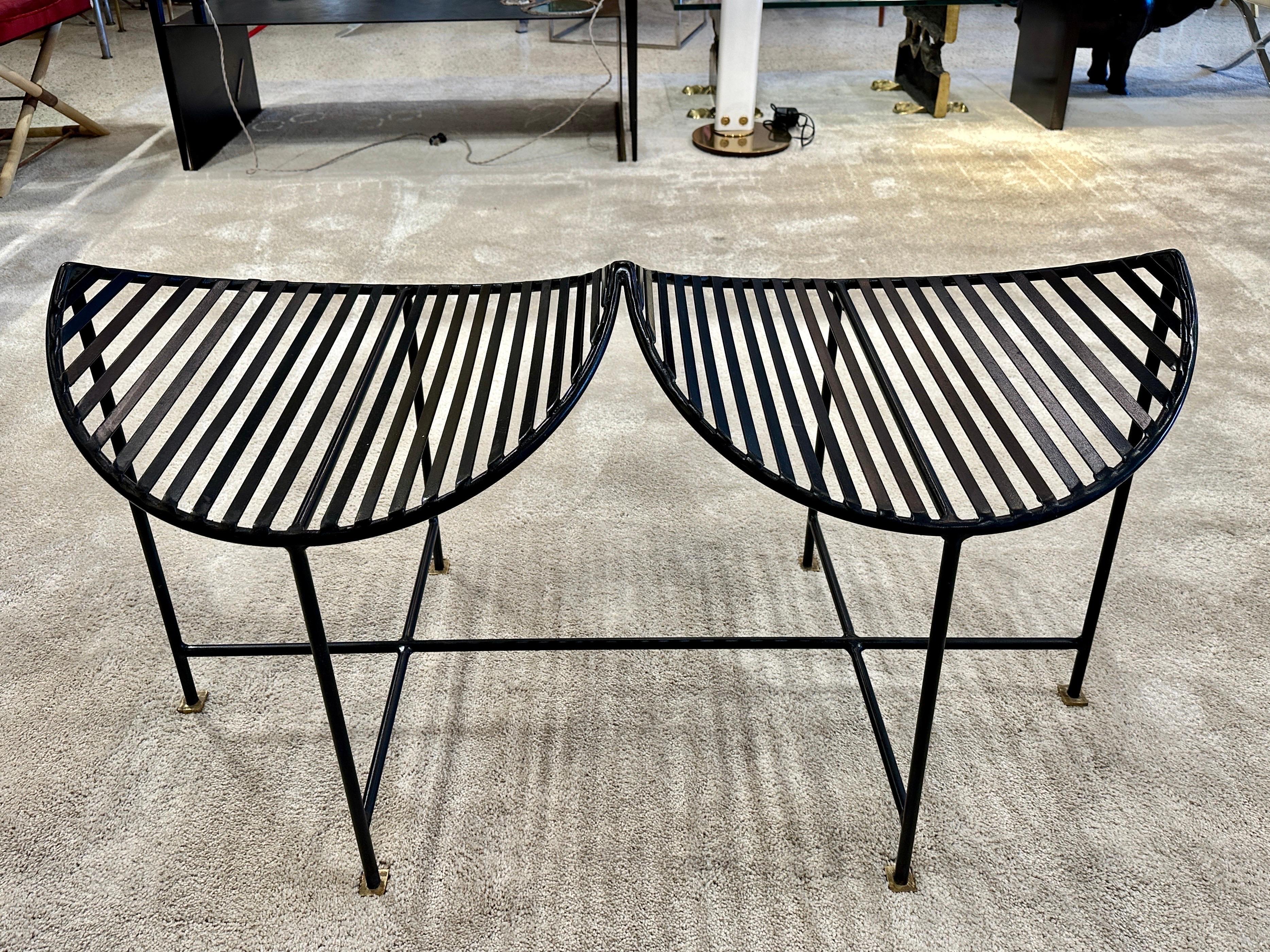 This wonderfully whimsical two-seat iron bench in black powder-coating and brass square feet, is a solid design element indoors or outdoors. The pictures are very accurate and the seats are VERY comfortable due to its curved design.  THIS ITEM IS