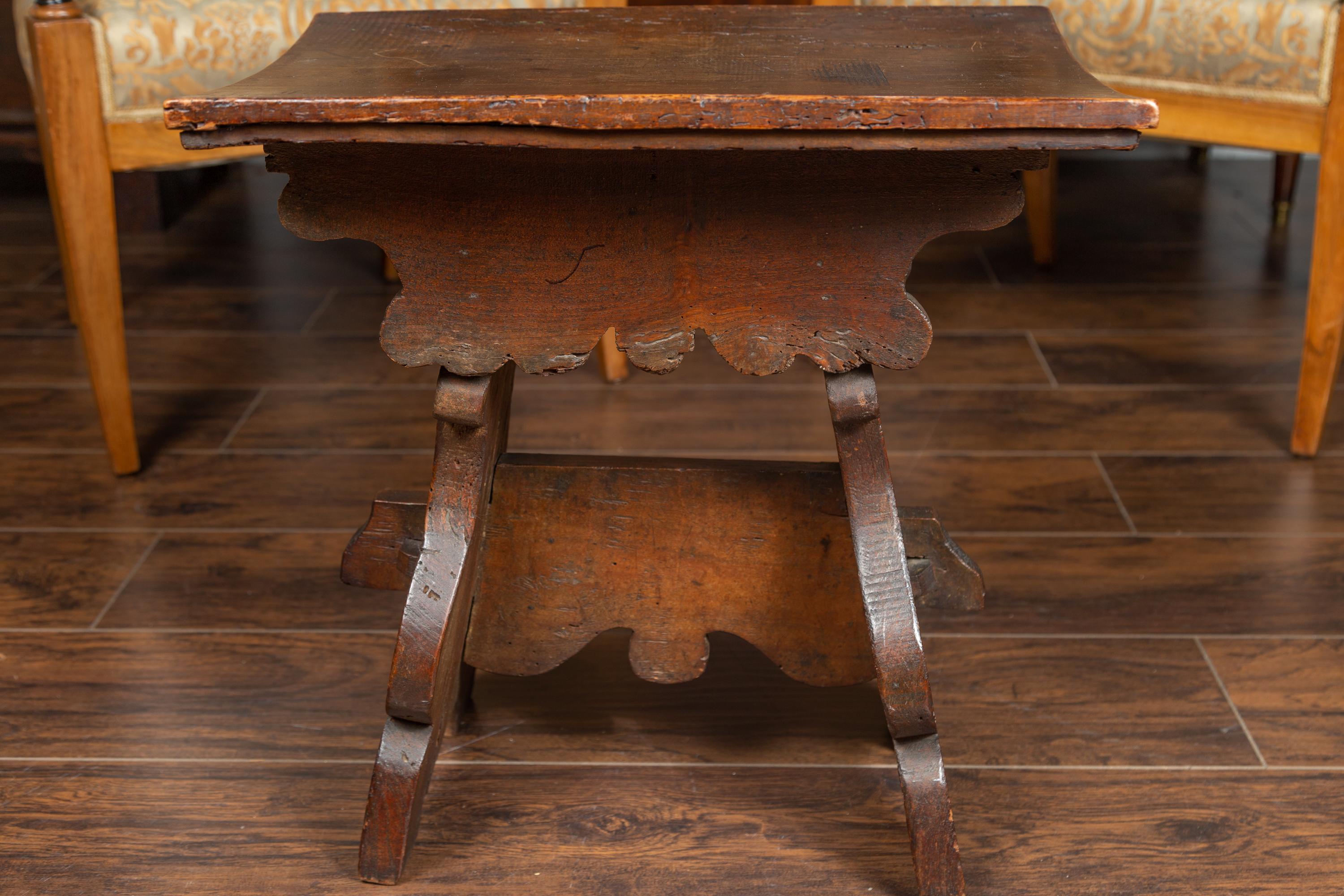 19th Century Rustic Italian 1800s Walnut Stool with Splaying Trestle Base and Carved Apron