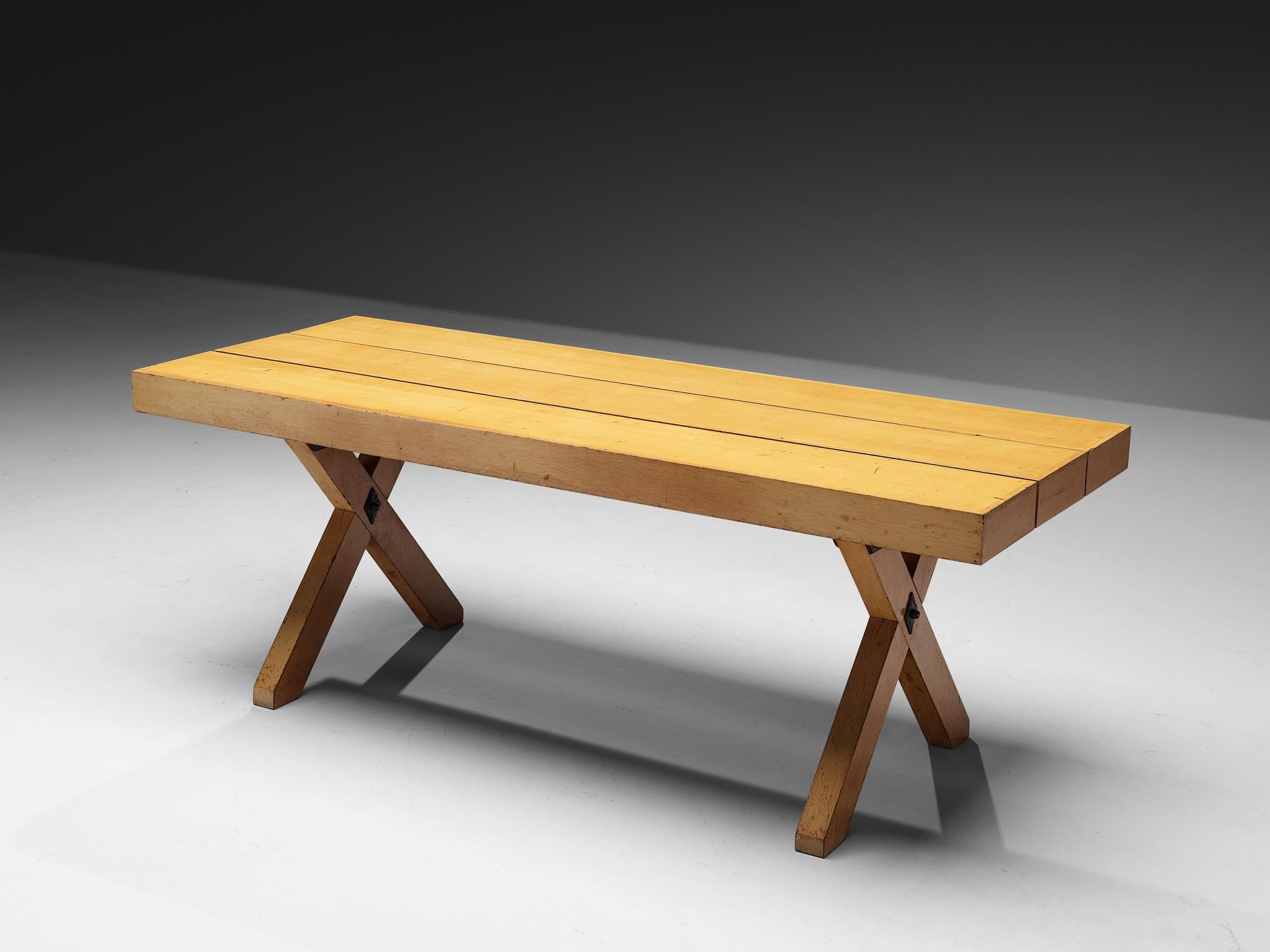 Dining table, oak, iron, Italy, 1970s 

Rustic Italian dining table in oak. The dining table holds a thick top, divided in three parts, executed in blond oak. Sturdy crossed legs give this table an interesting appearance. A noteworthy detail are the