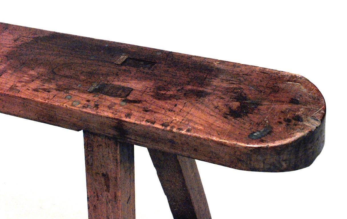 Rustic Italian Renaissance style fruitwood bench with a pair of open trestle legs (18th-19th century).
 