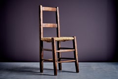Rustic ladder-back chair with straw seat France early 20th century