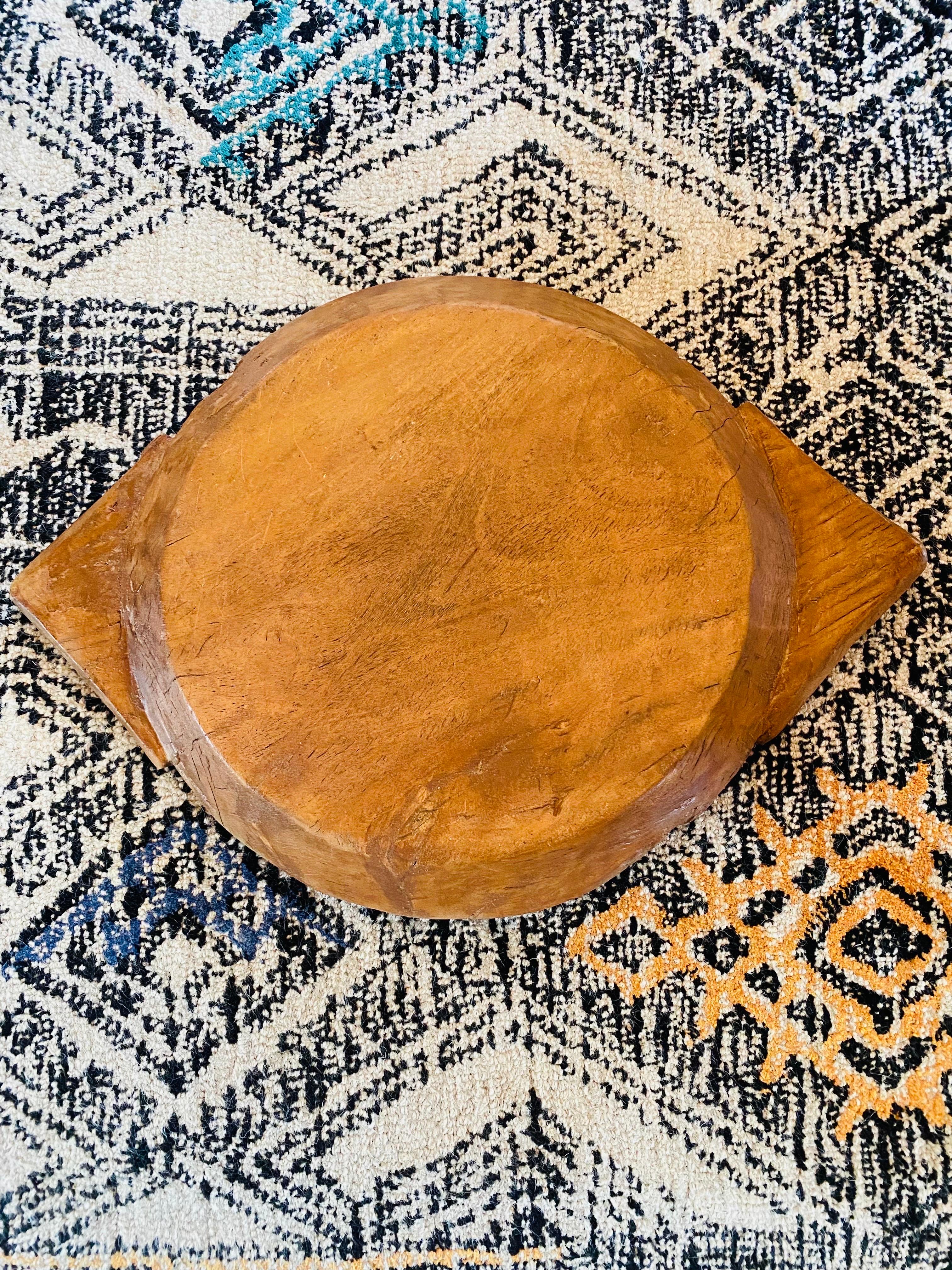 Sculptural large folk art style carved bowl with beautiful natural wood and patina acquired with age.  Sculptural, unique and organic piece that works with many styles.  Substance in shape and weight along with sculptural detailed edges that act