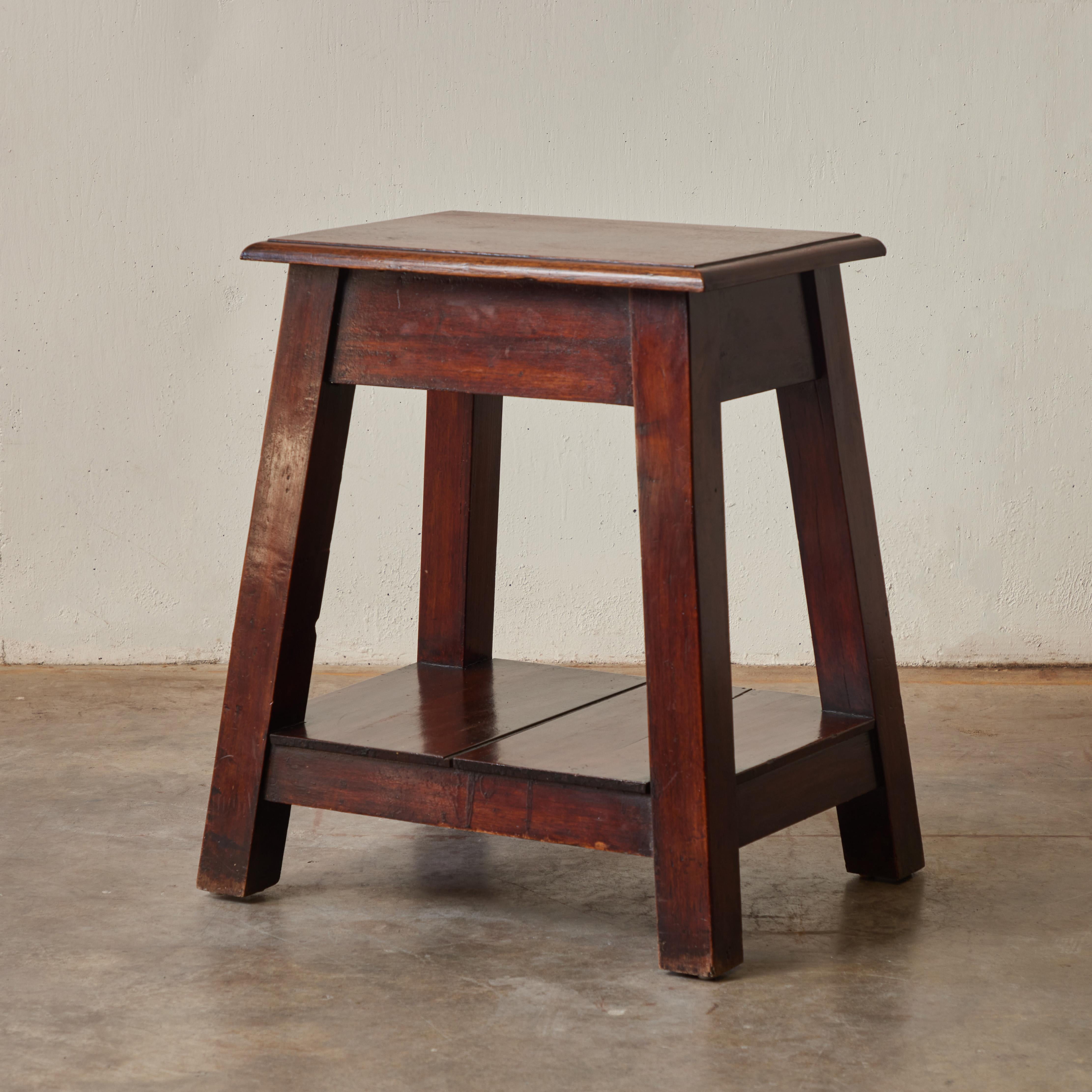Late 19th century English stool, side table, or plinth in a beautifully patinated russet teak wood. With its simple, strong geometry, the piece has a quiet, humble dignity and rustic charm. Highly versatile and with exceptional craftsmanship, this