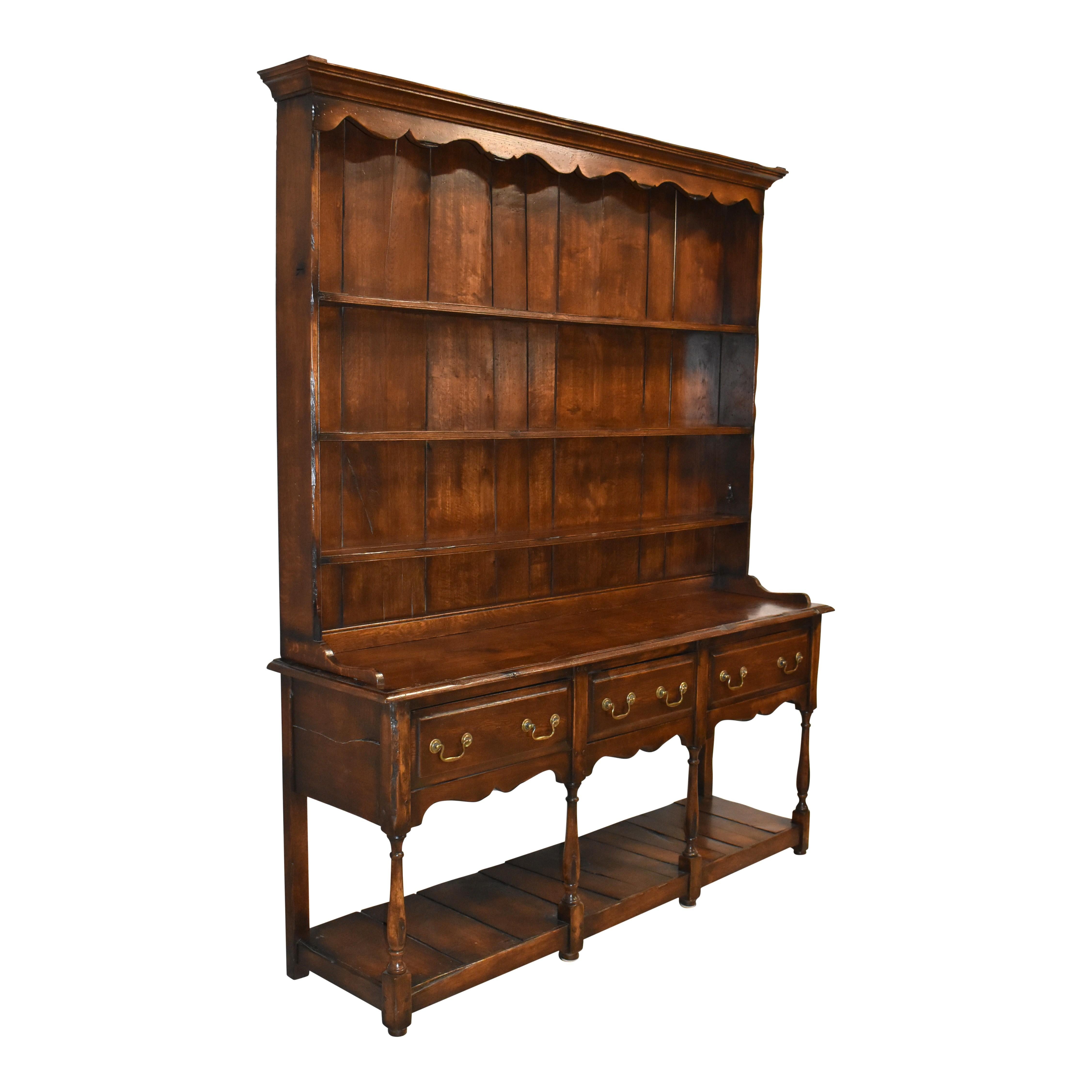 Bring Old World style to any room with this long display hutch. Crafted in the early-20th century from oak that is not quartersawn for a more rustic look, it features an upper display gallery that sits atop a lower stand. The top gallery showcases a
