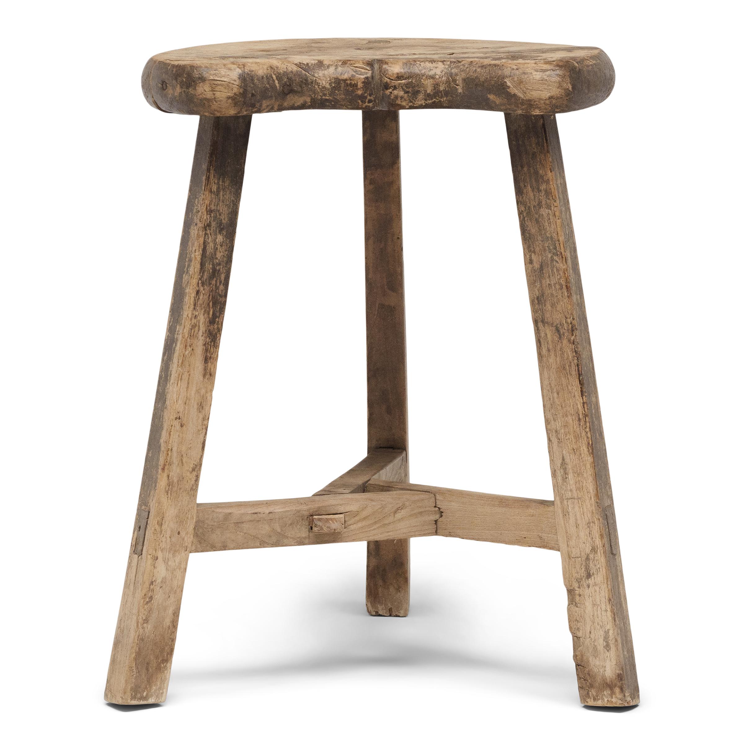 When we look at the seat of this early 20th-century tri-leg stool, we can't help but see the twinkling face of the man in the moon. With a rustic form and weathered surface, the courtyard stool adds effortless texture to any interior, ideal as a