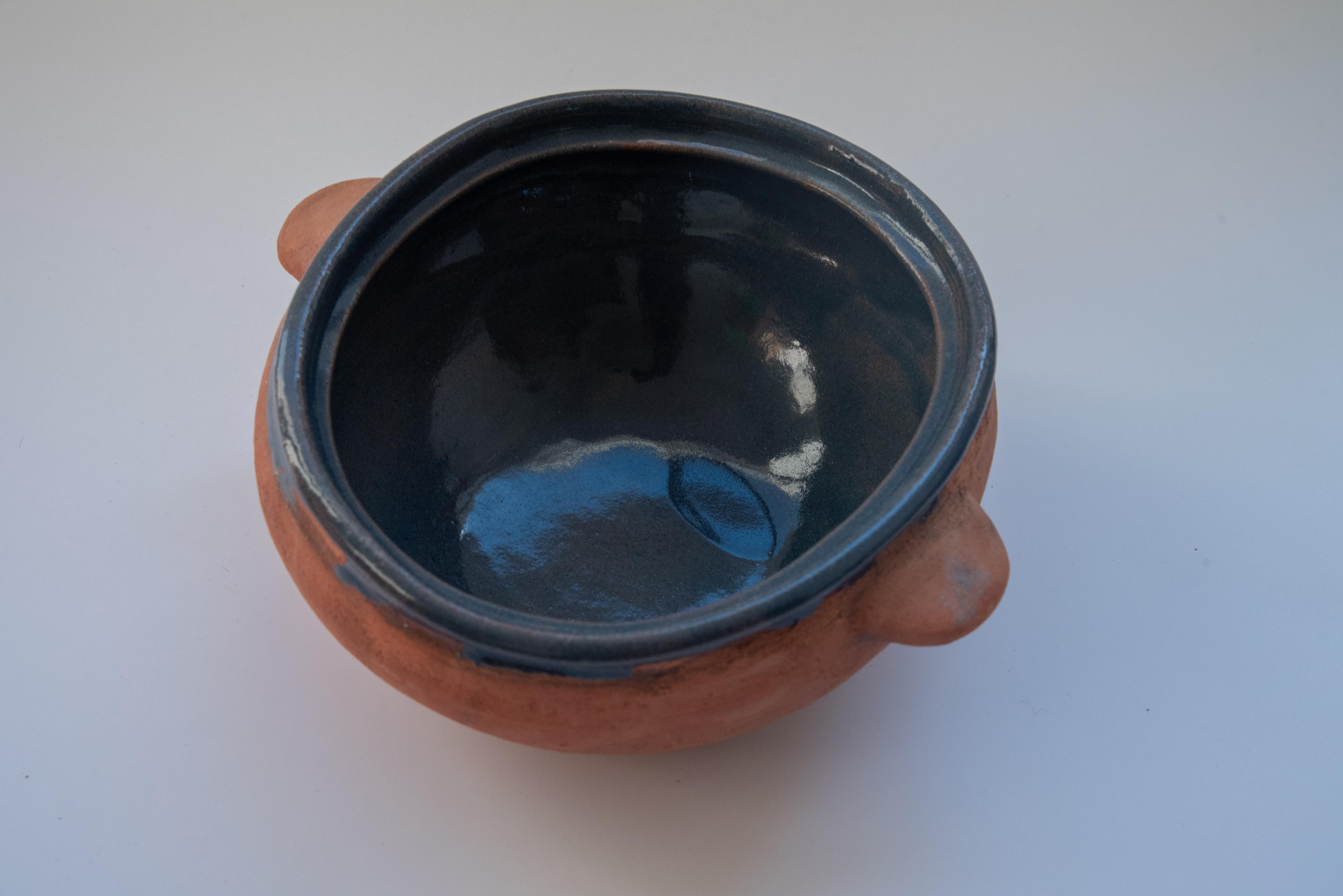 This beautiful utilitarian ceramic fruit bowl is covered on the surface with lead free blue pigment. Made in Oaxaca, Mexico, by artist Rolando Regino, Porras, son of famous folk artist Dolores Porras. This traditional design is perfect for rustic