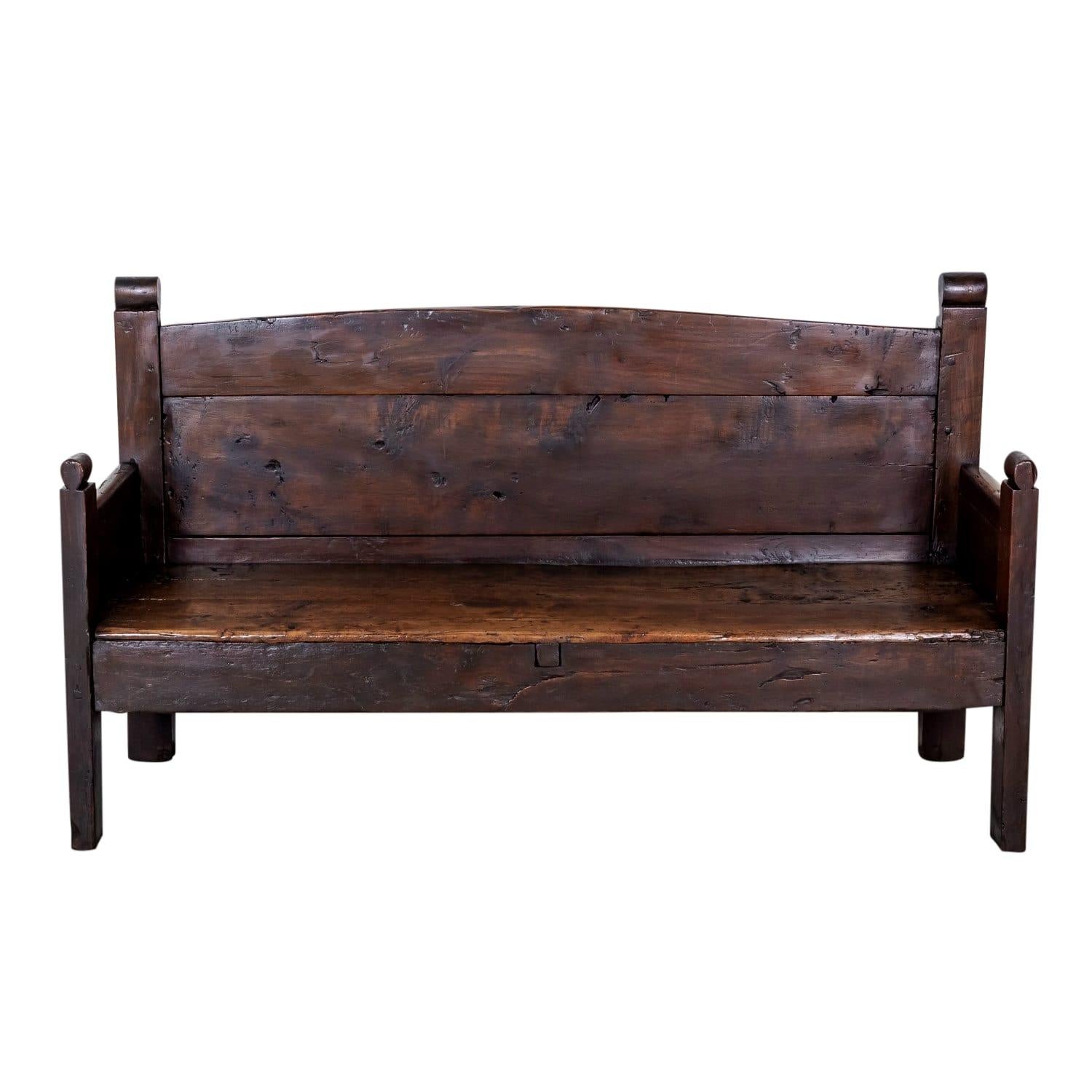 Mid-18th century rustic Spanish bench handcrafted near Valencia on Spain's southeastern coast of solid walnut, having four sculptural posts that rise up from each leg, circa 1750s. This handsome bench has aged and weathered to a beautiful patina