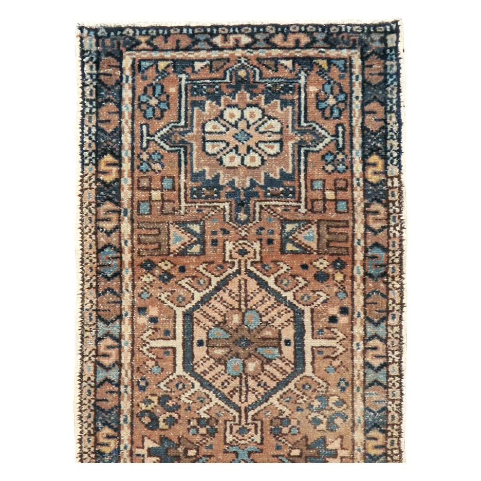 A vintage Persian Karajeh rug in small runner format handmade during the mid-20th century with a rustic appeal.

Measures: 1' 10