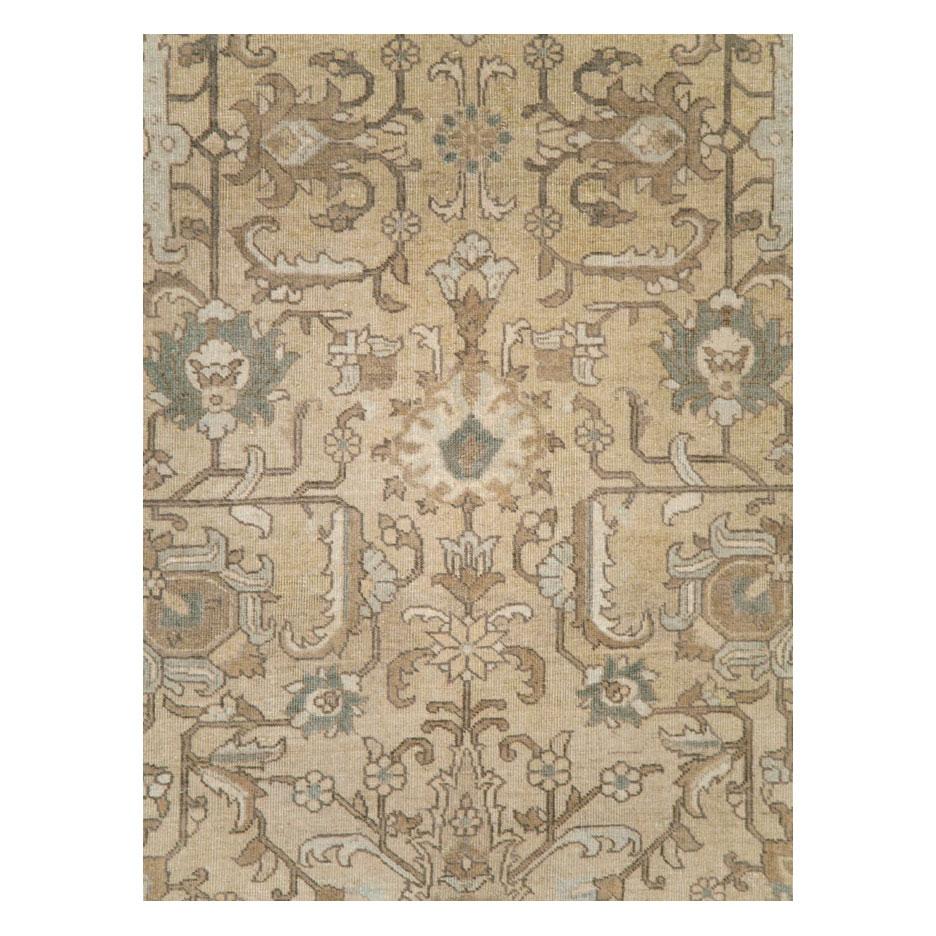A rustic vintage Persian Tabriz room size accent rug handmade during the mid-20th century in cream neutral tones.

Measures: 7' 0