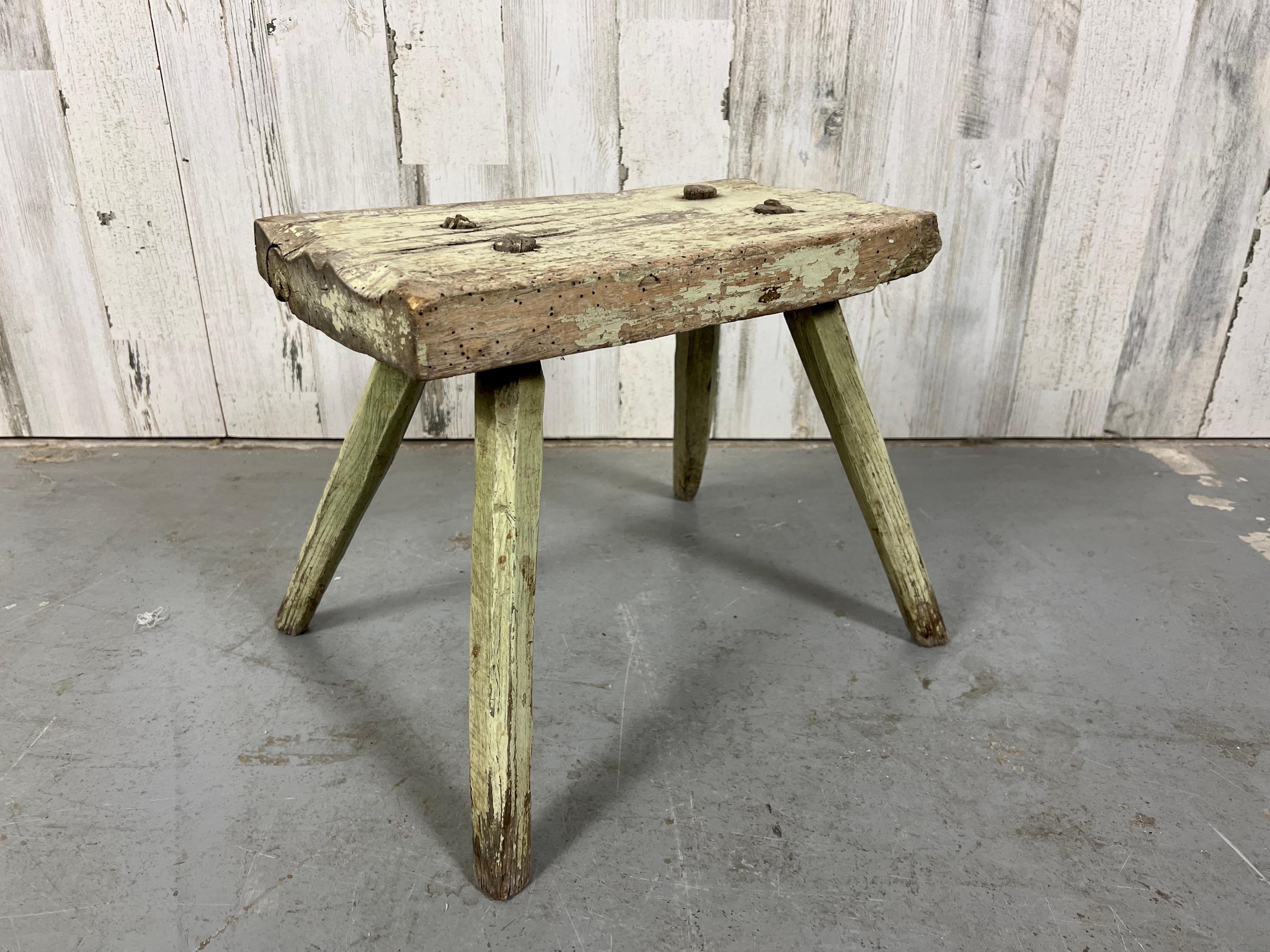 Very rustic hardwood milking stool with original milk paint in a mossy green. This would also make a great drinks table.
