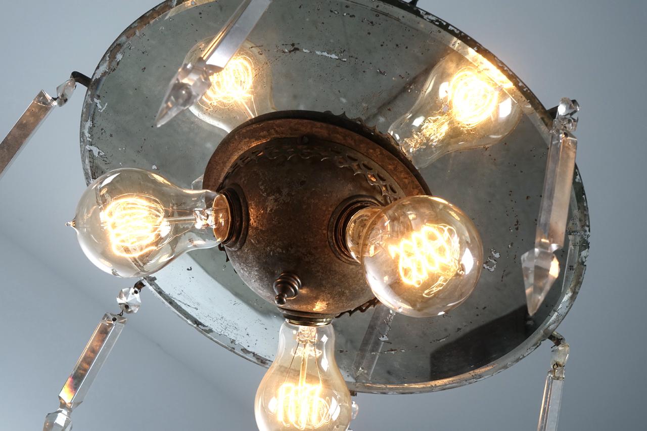 The finish on this rustic 3 bulb fixture is untouched, the mirror and domed bulb cluster all have the original aged finish and some rough edges. With 6 hanging crystals the lamp has an odd and likeable look that works.