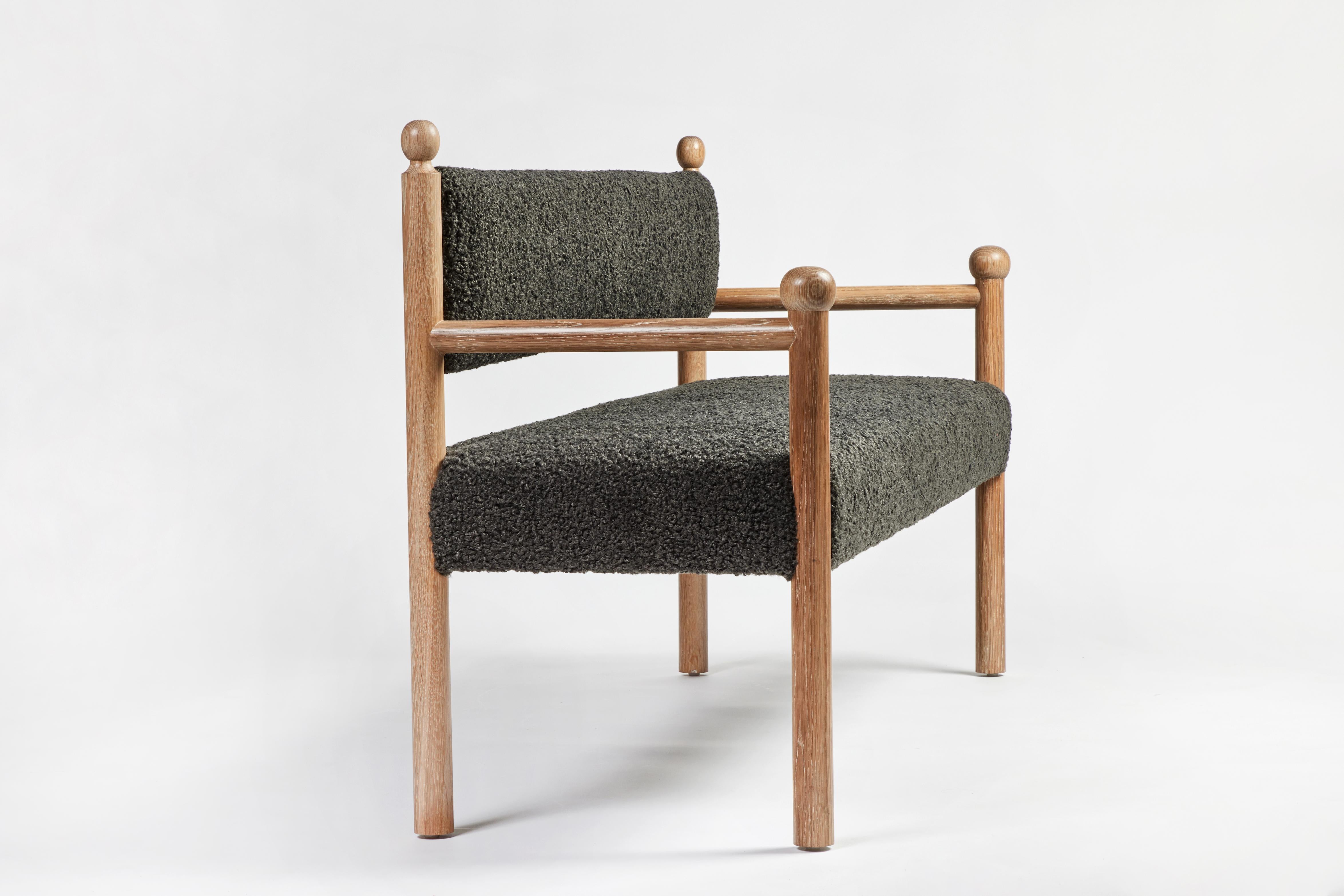 The Martin and Brockett Sydney Bench has a wood frame with final details on the chair back and arm. Upholstered seat and back. In light fumed on oak. 

Fabric is C.O.M. only- 6 yards.

