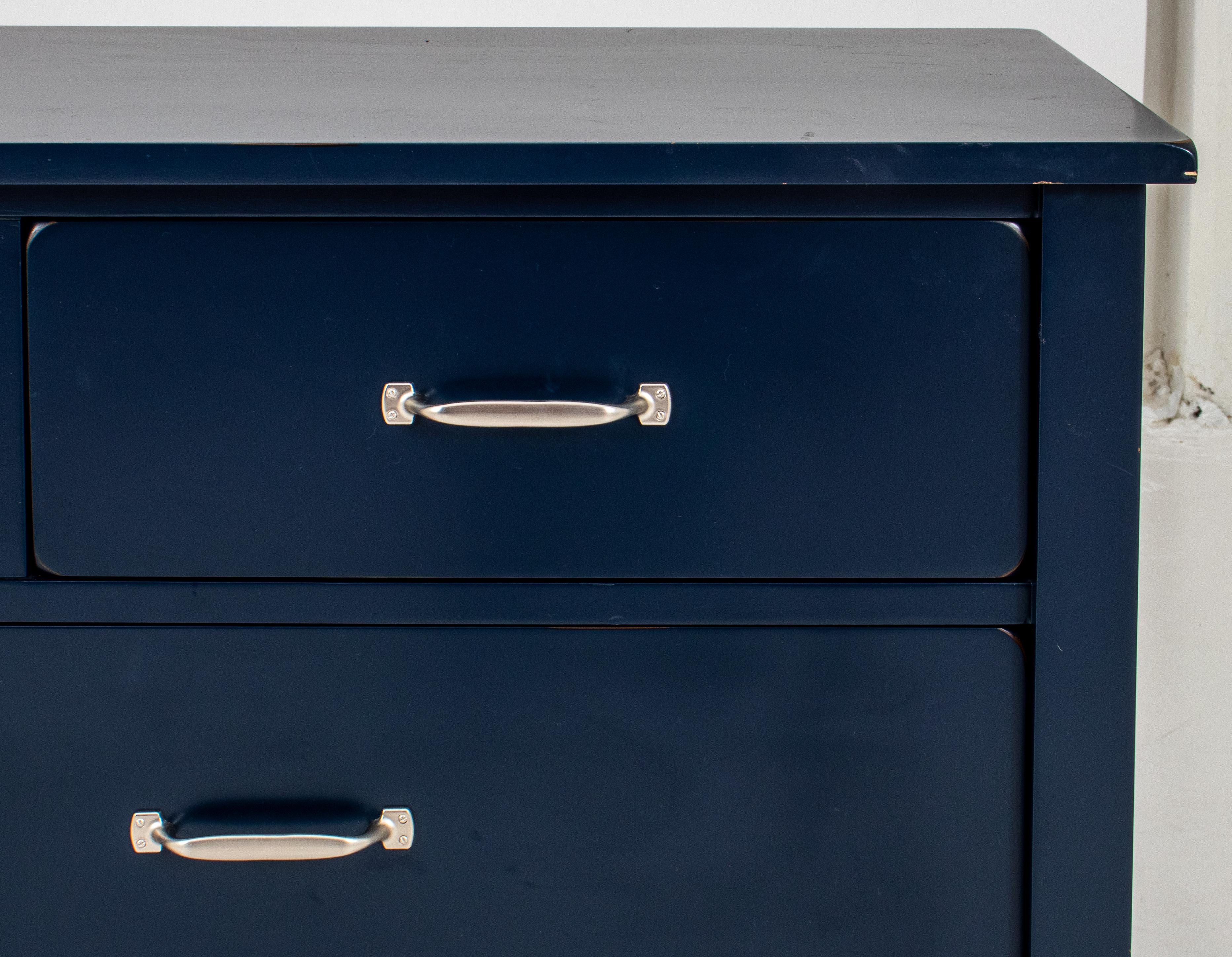 Rustic Modern blue-painted dresser, with rectangular top above three short drawers over two long, above four square legs conjoined by a shelf-stretcher. 

Measures: 32.5