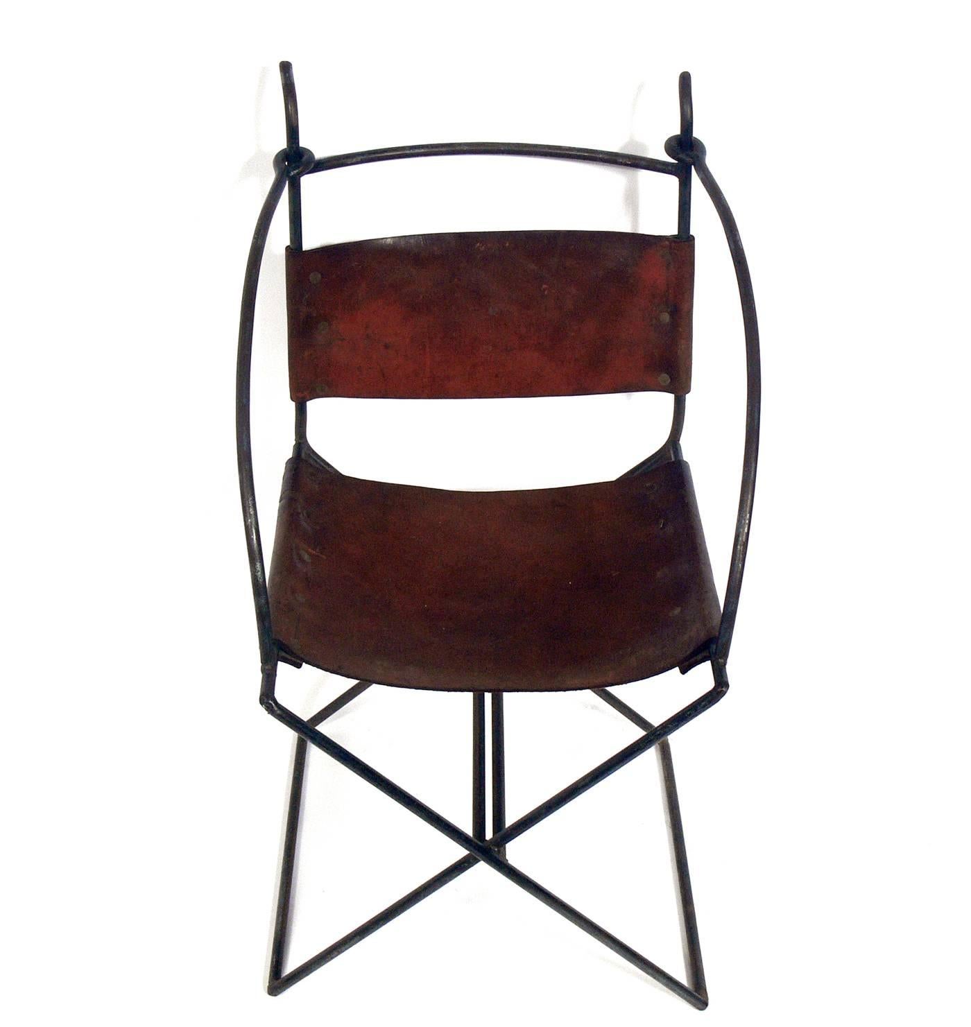 Rustic modern iron and leather chair, American, circa 1960s. Handmade by a Vermont artist in the 1960s, this chair retains its warm original patina to the iron frame and thick cognac color saddle leather.