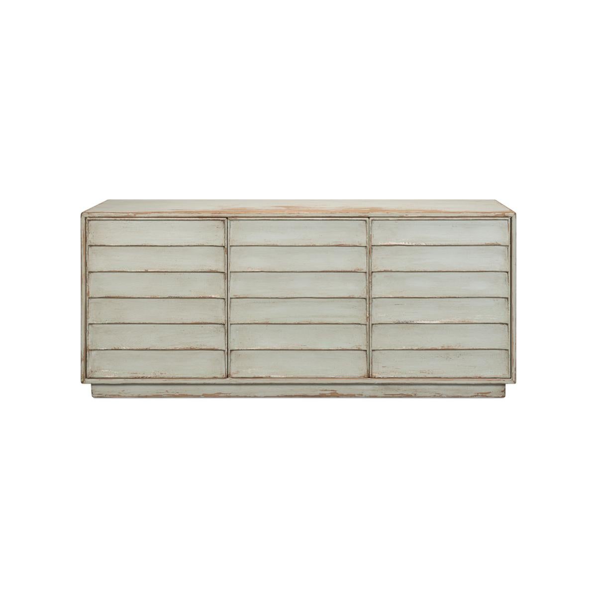 Made with reclaimed pine in an antiqued and distressed finish sage paint color. Three cabinet doors open to reveal a painted interior with removable shelves. The cabinet is raised on a square stepped-back plinth base.

Dimensions: 74
