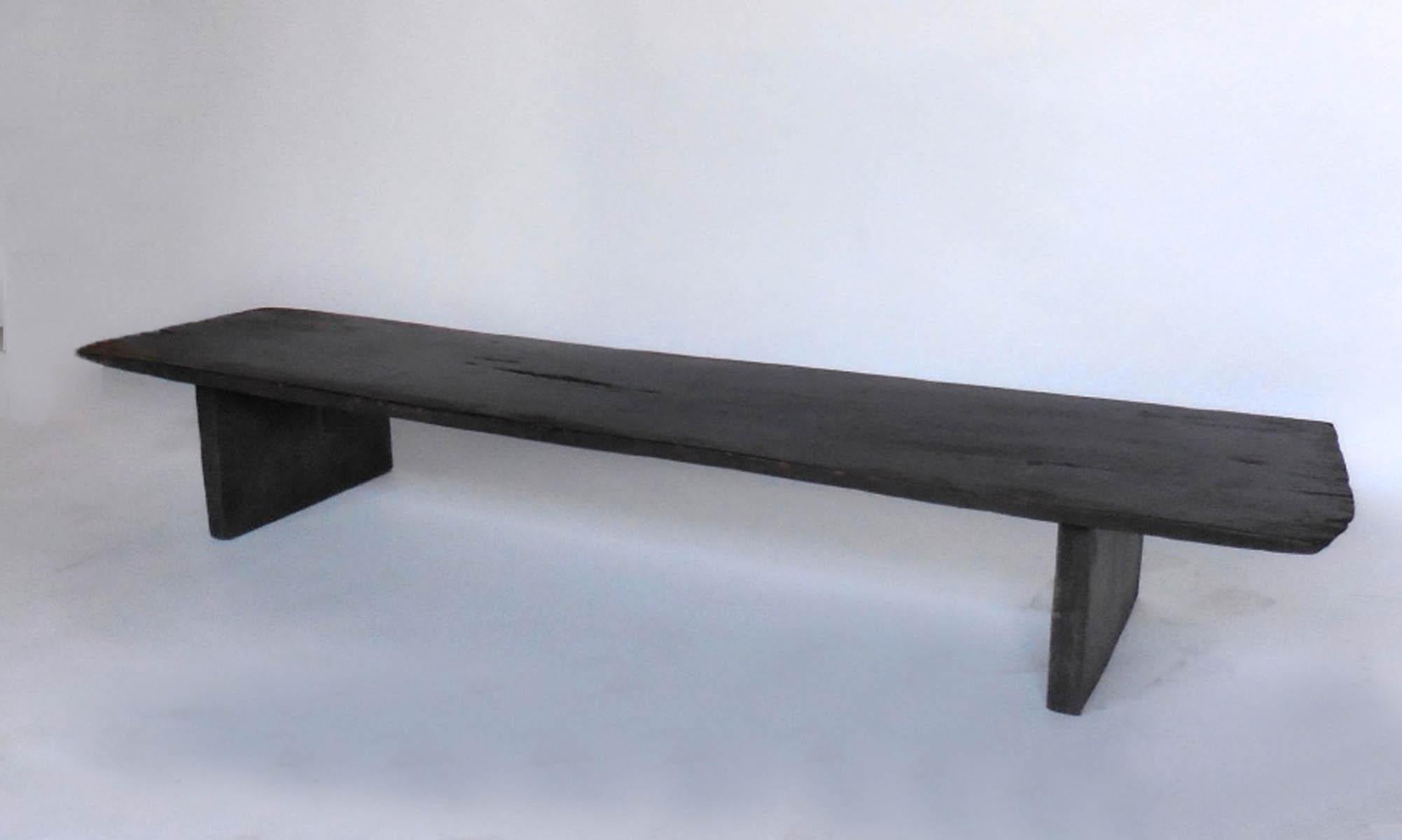 Axel Vervoordt style low coffee table made from 19th century one wide board plank in a dark almost ebony color. Beautiful patina, modern lines. Great low coffee table or console or bench.