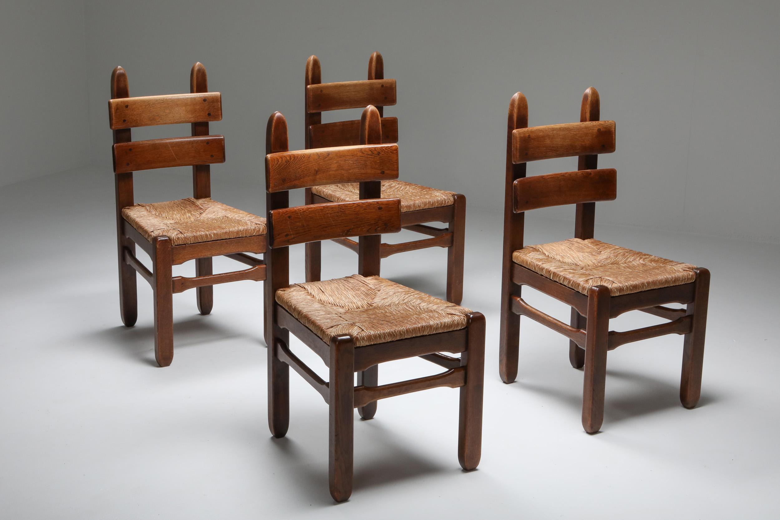 Solid oak chairs, set of four, original cord seating.

Rustic modern dining chairs
their slightly bigger size make them like small thrones
Very heavy and sturdy pieces with super gorgeous patina and character.
   