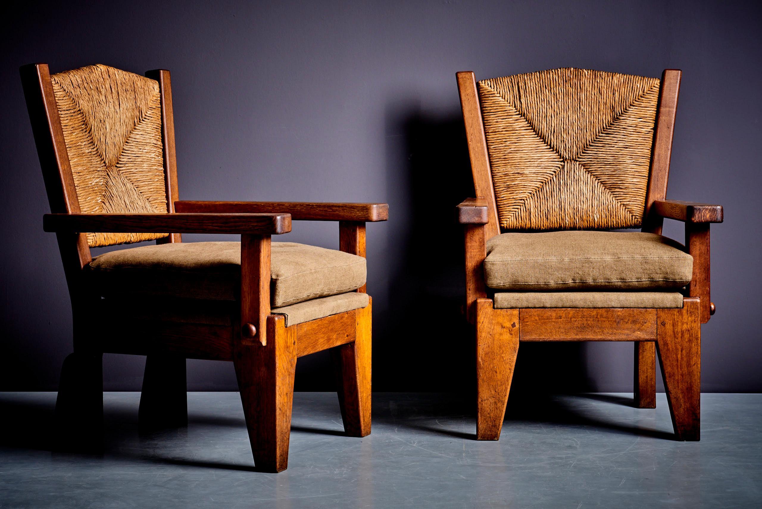 This striking pair of rustic armchairs combines exceptional craftsmanship with natural materials, creating a perfect blend of aesthetic charm and functional comfort. The solid wood frames, with their rich, warm finish, highlight the grain and