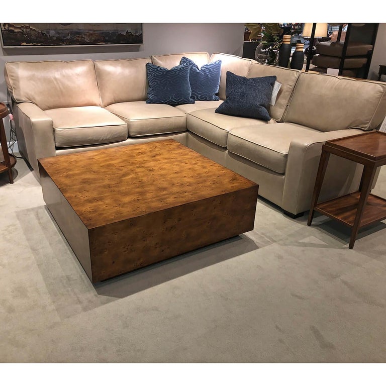 Rustic Modern square coffee table, with a plinth base and hidden wheels, has a “rustic” warm brown finish with subtle visual distressing and hand-rubbed bee’s wax finish on mappa burl veneer.

Dimensions: 42