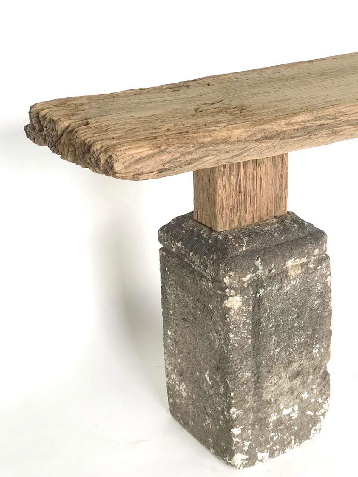 Rustic modern console table consisting of weathered 2.5 inch thick Japanese Elm board atop a pair of 19th century Guatemalan carved stone bases. Naturally worn patina.