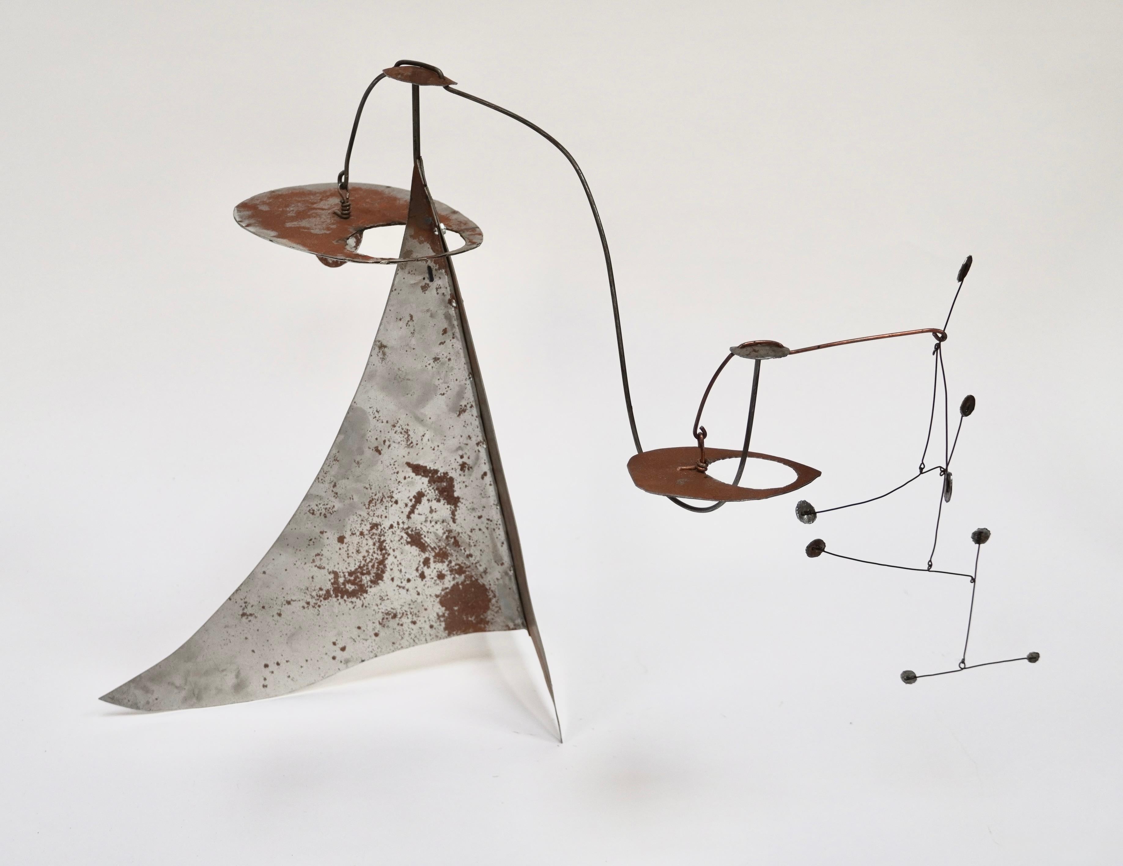 Hand crafted table top mobile created out of cut and welded steel. The sculpture is a blend of both the rustic and modernist aesthetic. Having developed a patina to the steel from over the years and the naivety of the construction gives it a special