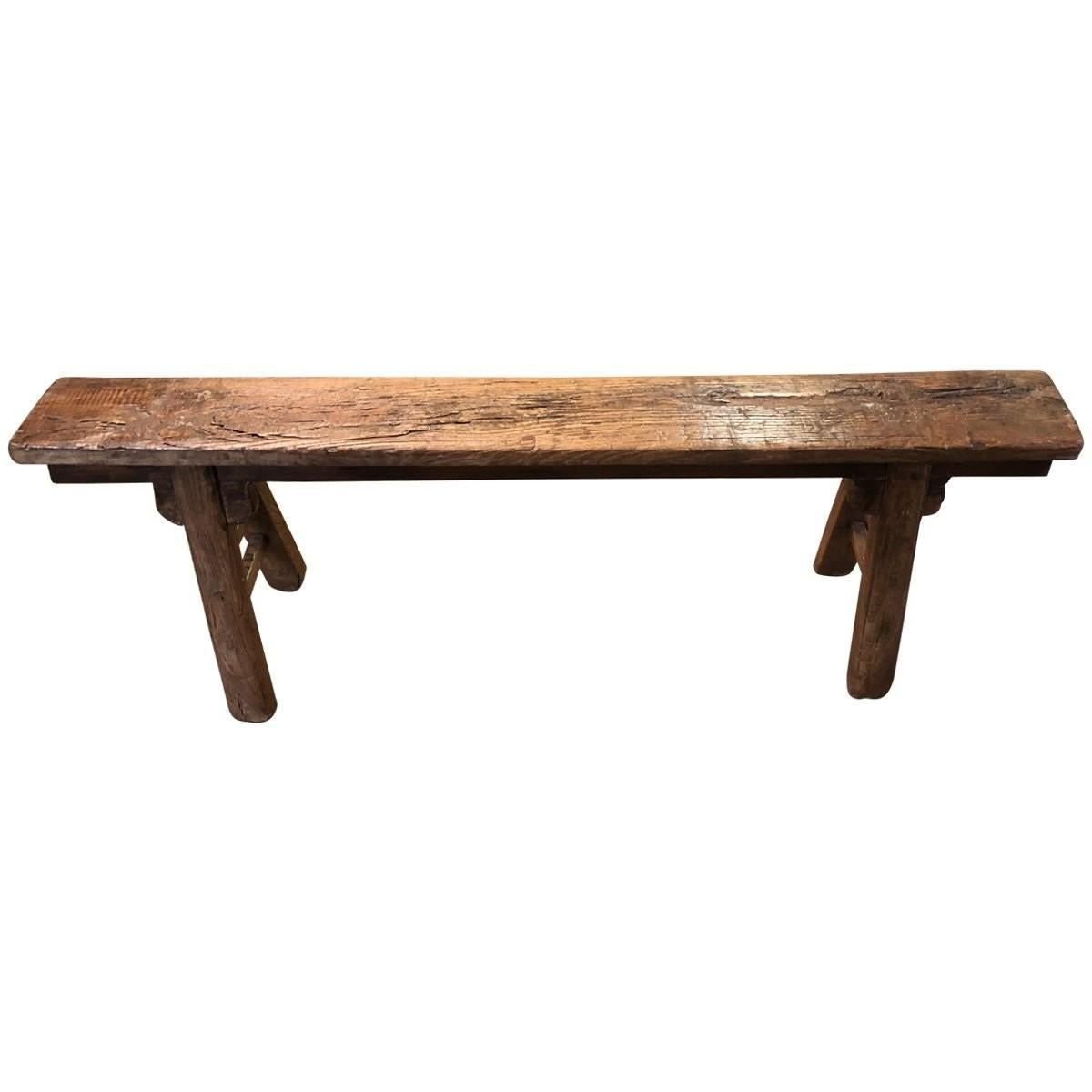 Understated but sophisticated, this rustic Chinese bench is composed of elm wood and features a narrow seat. This eye-catching bench brings instant elegance to any space.
 