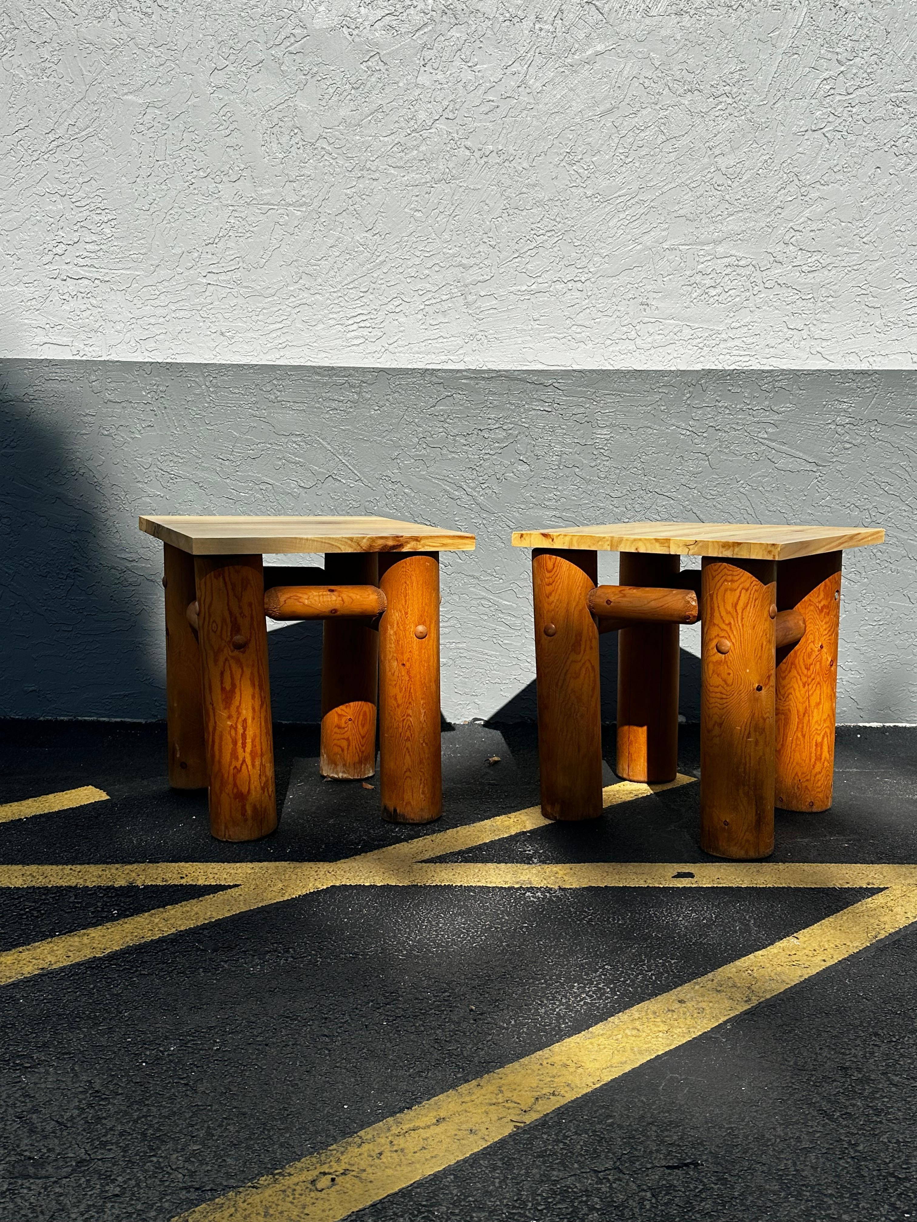 A vintage European occasional table. This wonderfully informal European occasional table features a thickly cut honed and fossilized stone top, square in shape, which is supported by four smoothed, natural wood limbs. The four larger limb feet have