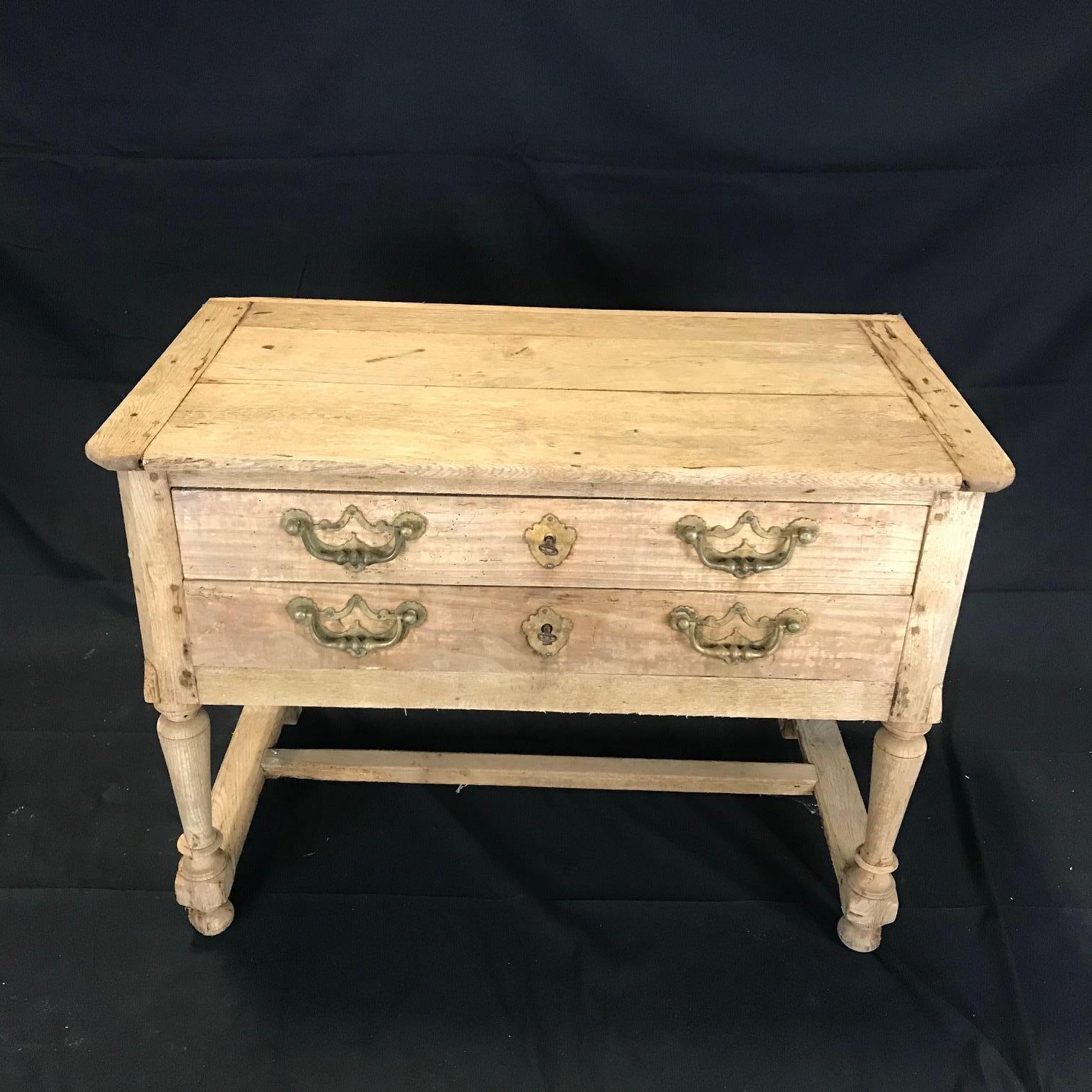 A charming unpainted rustic French side table or console having two drawers with keys.