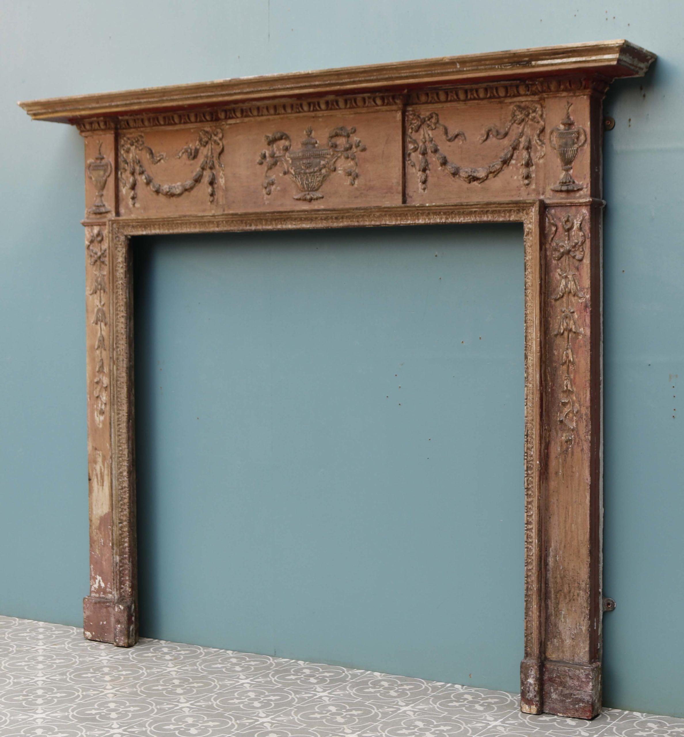 Rustic Neoclassical Style Fire Surround. A mid 19th century Pine and Composition fire surround with a decorative frieze of urn and swag mouldings, in the Adam style.
 
Additional Dimensions
 
Opening height 96.5 cm
 
Opening width 102 cm
 
Across