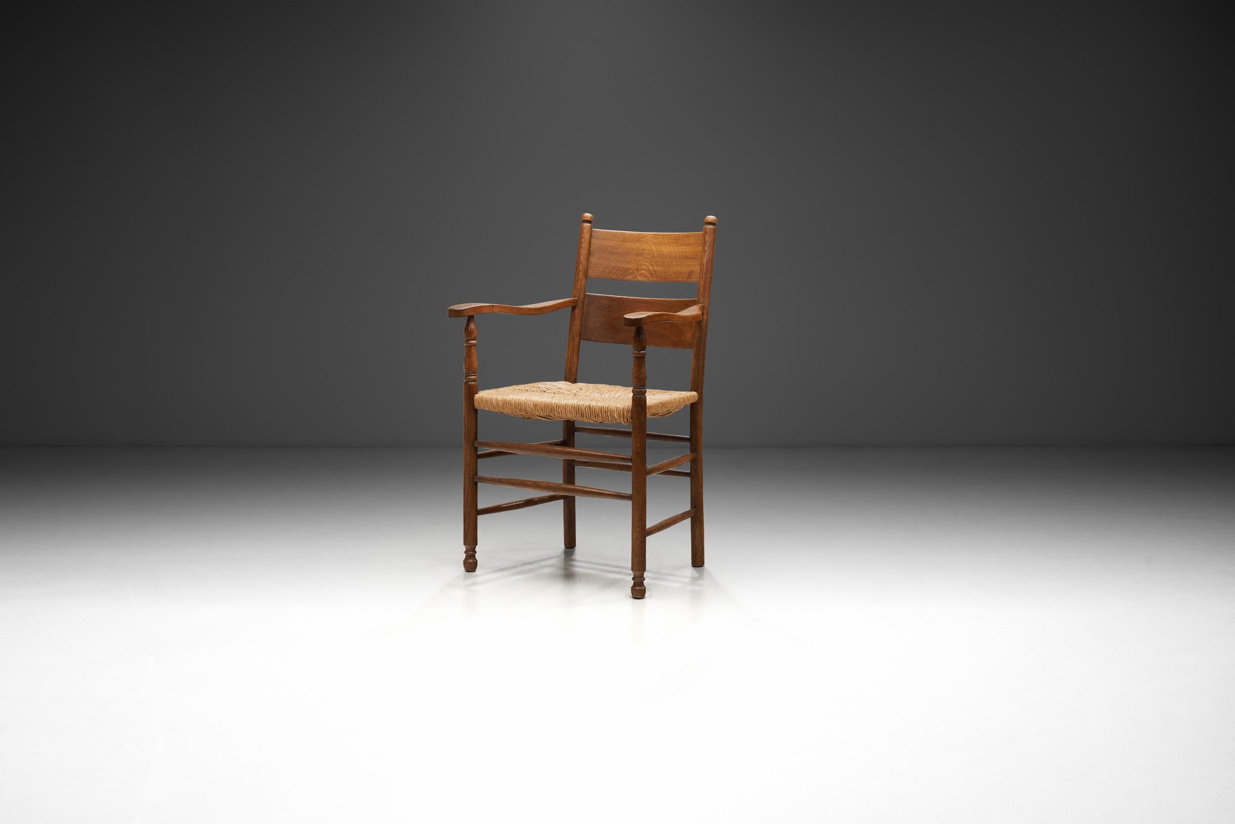 This rustic armchair embodies the aesthetic, practicality and functional design that was valued in European homes of the early 20th century. Displaying artisanal techniques such as weaving and beautifully carved details, pieces such as this chair