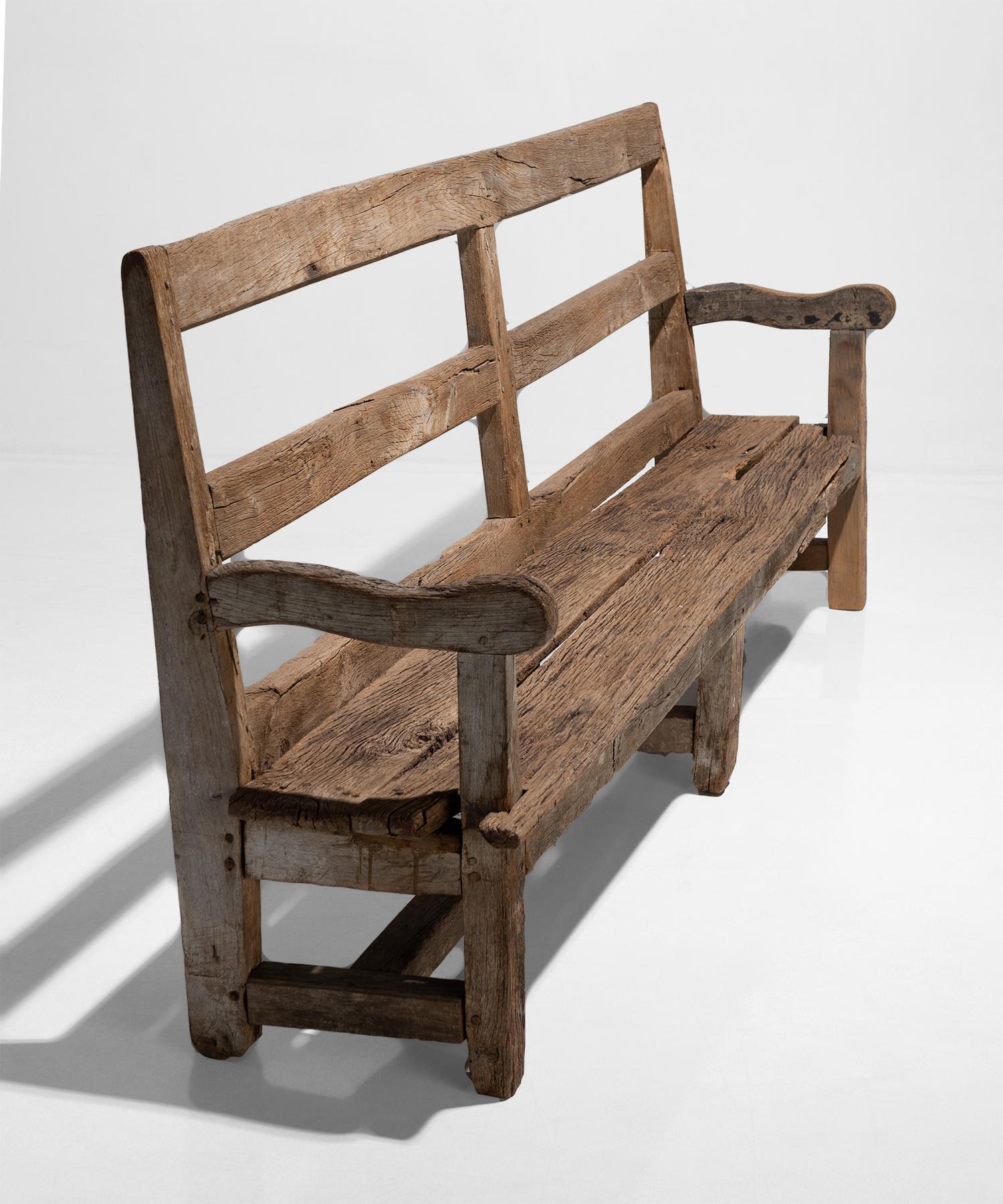 Oak bench with high back and remnants of original period paint.
  