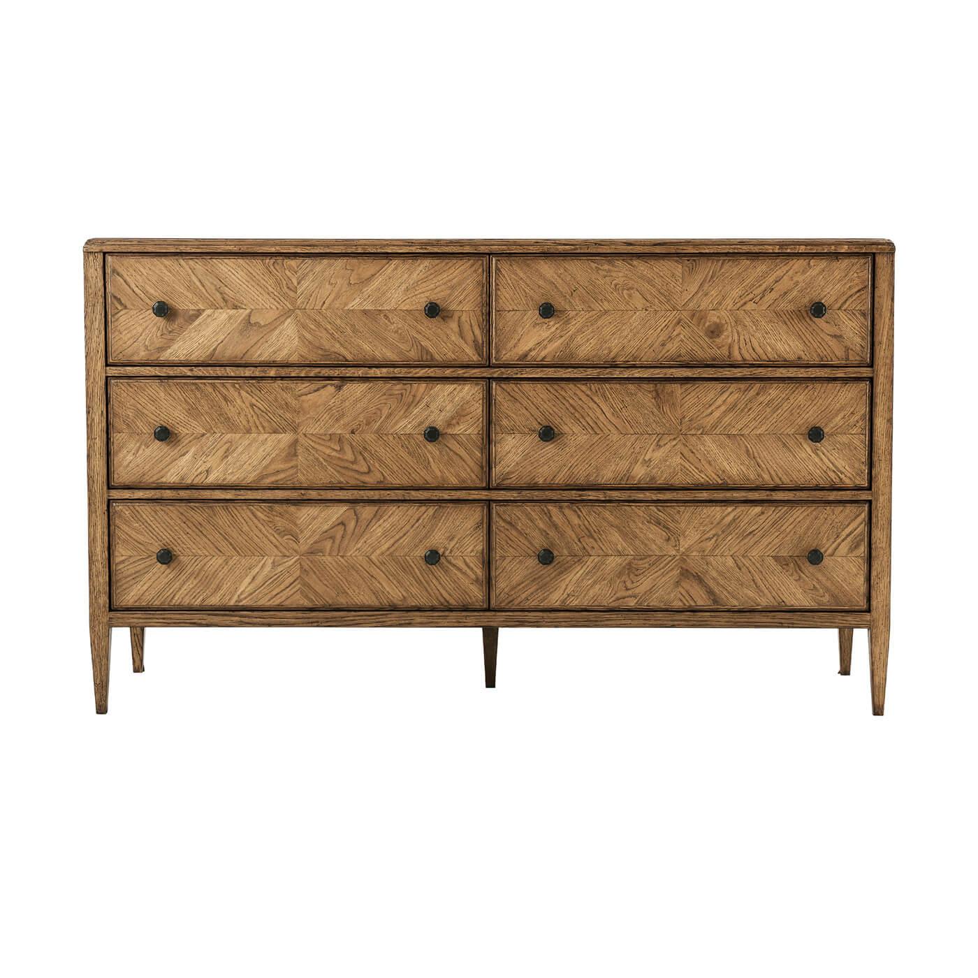 A rustic-style oak parquetry dresser with six hand-veneered drawers accented with Verde Bronze finish handles and tapered oak legs. 

Shown in dawn finish
Dimensions
63.5