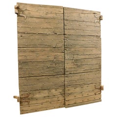 Rustic old double entrance door in chestnut with nails, Italy