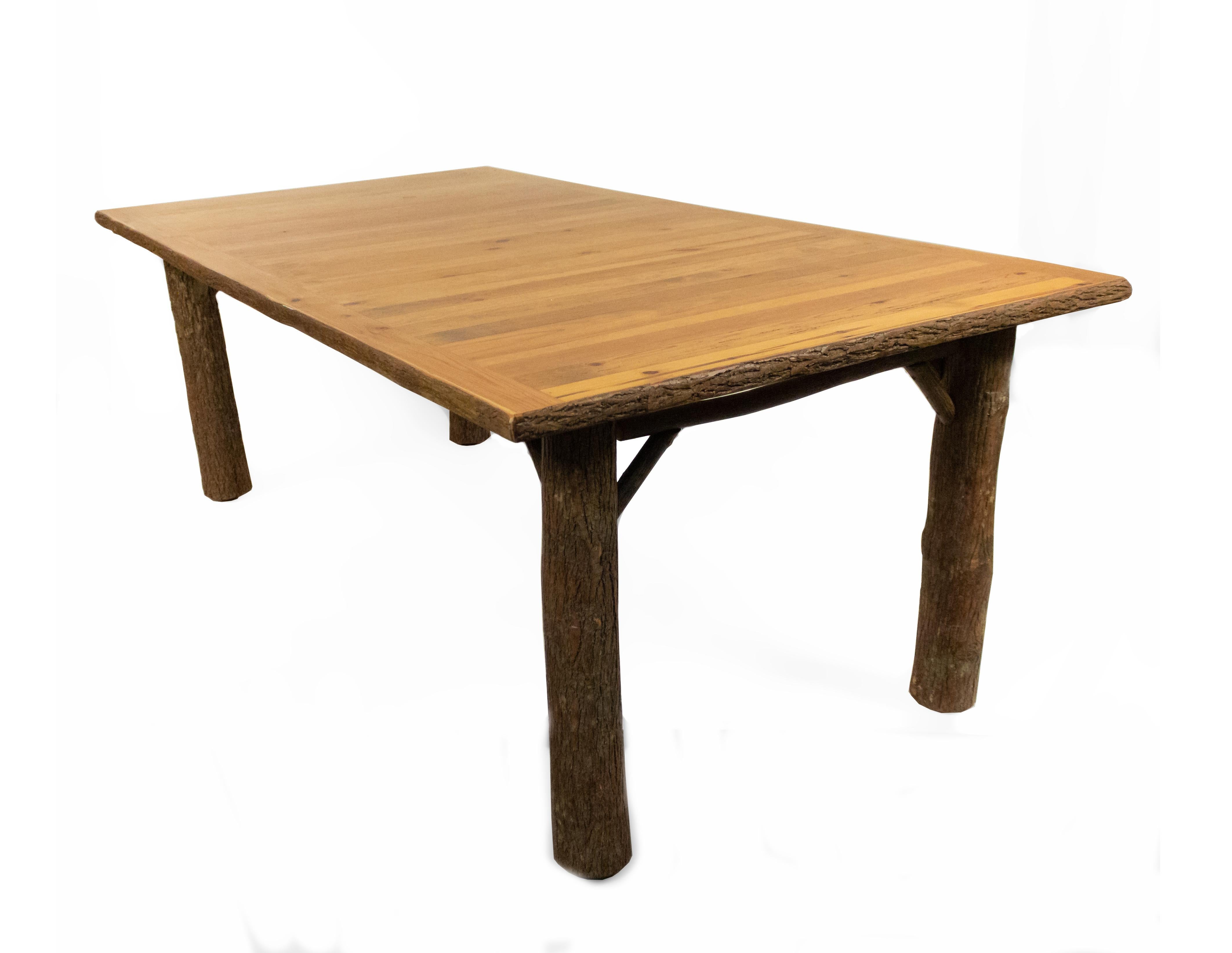 Late 20th century rustic old hickory large rectangular dining table with exposed bark legs and pine plank top (brass tag).