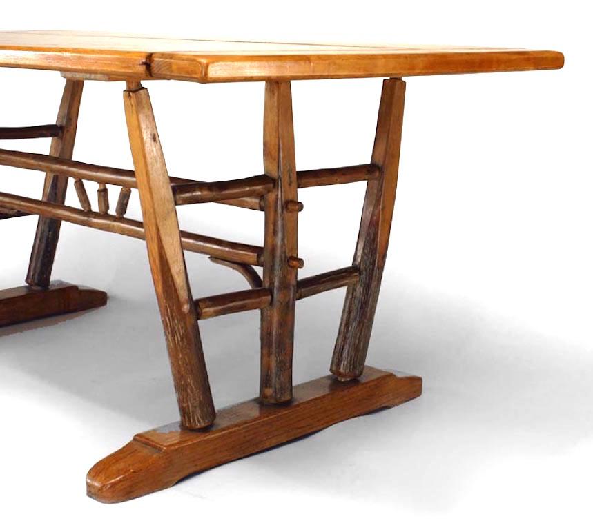 Rustic Old Hickory (Circa 1940) dining table with rectangular top on trestle supports joined by a spindle stretcher (branded: Old Hickory; Martinsville, Indiana)
