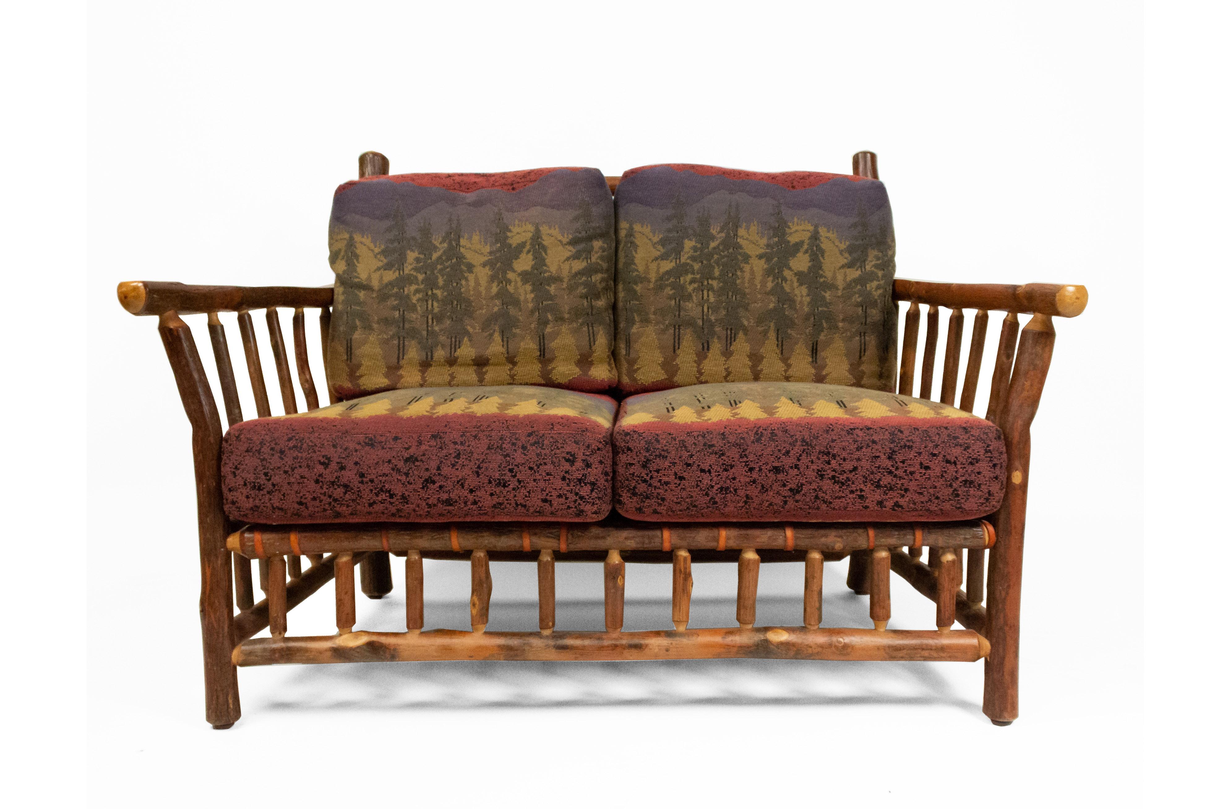 Rustic Old Hickory (20th Century) loveseat with spindle sides, back, and base with 4 forest print upholstered cushions (brass Old Hickory tag).