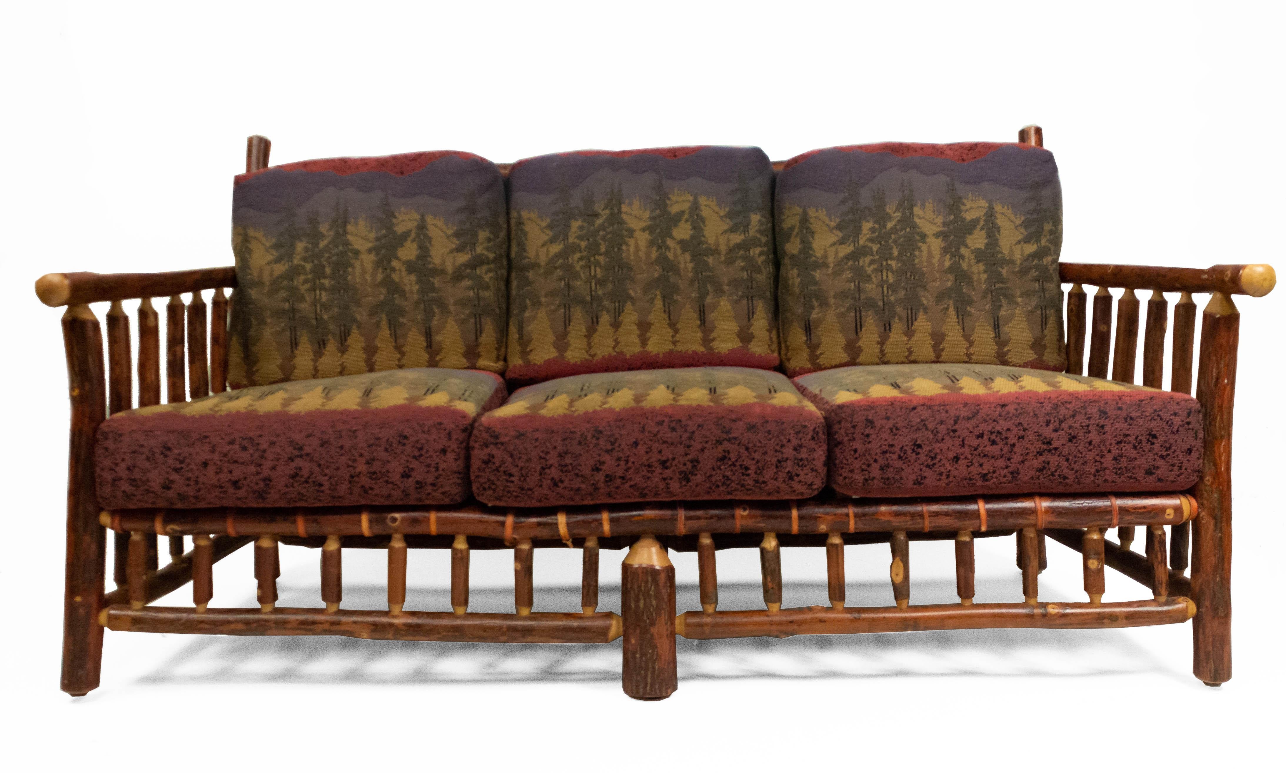 Rustic Old Hickory style (20th century) sofa / settee with spindle design sides, back, and base with 6 forest print upholstered cushions (brass Old Hickory tag).