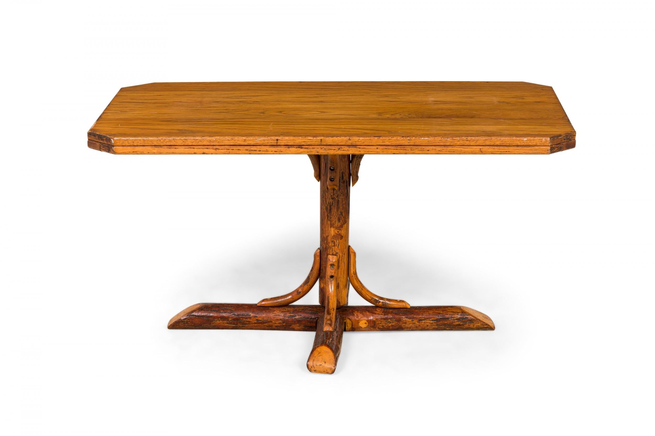 Rustic Old Hickory (Mid-20th Century) coffee table with a rectangular oak top with canted corners supported by a pedestal base ending in an x-shaped log foot with bentwood supports. (signed with brand on bottom, OLD HICKORY).