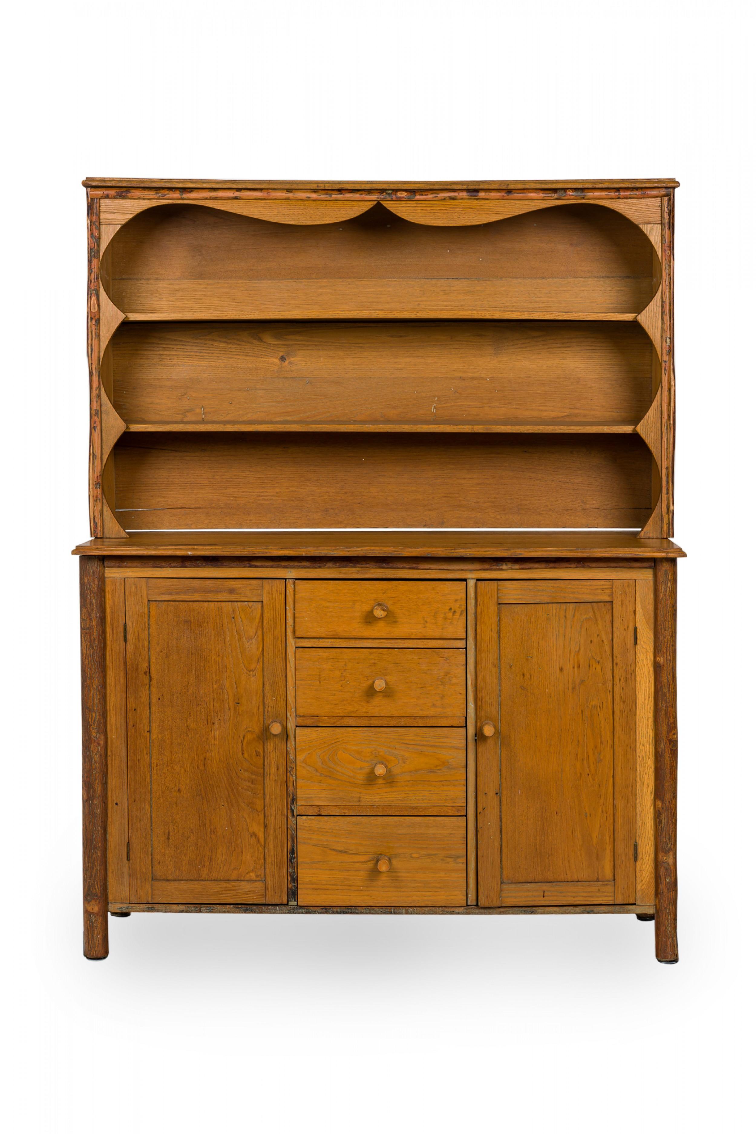 Rustic Old Hickory (mid-20th century) two-piece oak kitchen hutch with an open two-shelf upper section resting on a lower cabinet base with four central drawers flanked by two doors, all with turned wooden knob drawer handles and resting on four