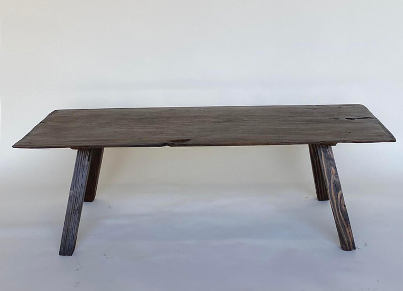 Rustic coffee table consisting of a one wide board top and newer legs. Great natural dark patina. Age appropriate wear throughout but fully functional. Please see photos.