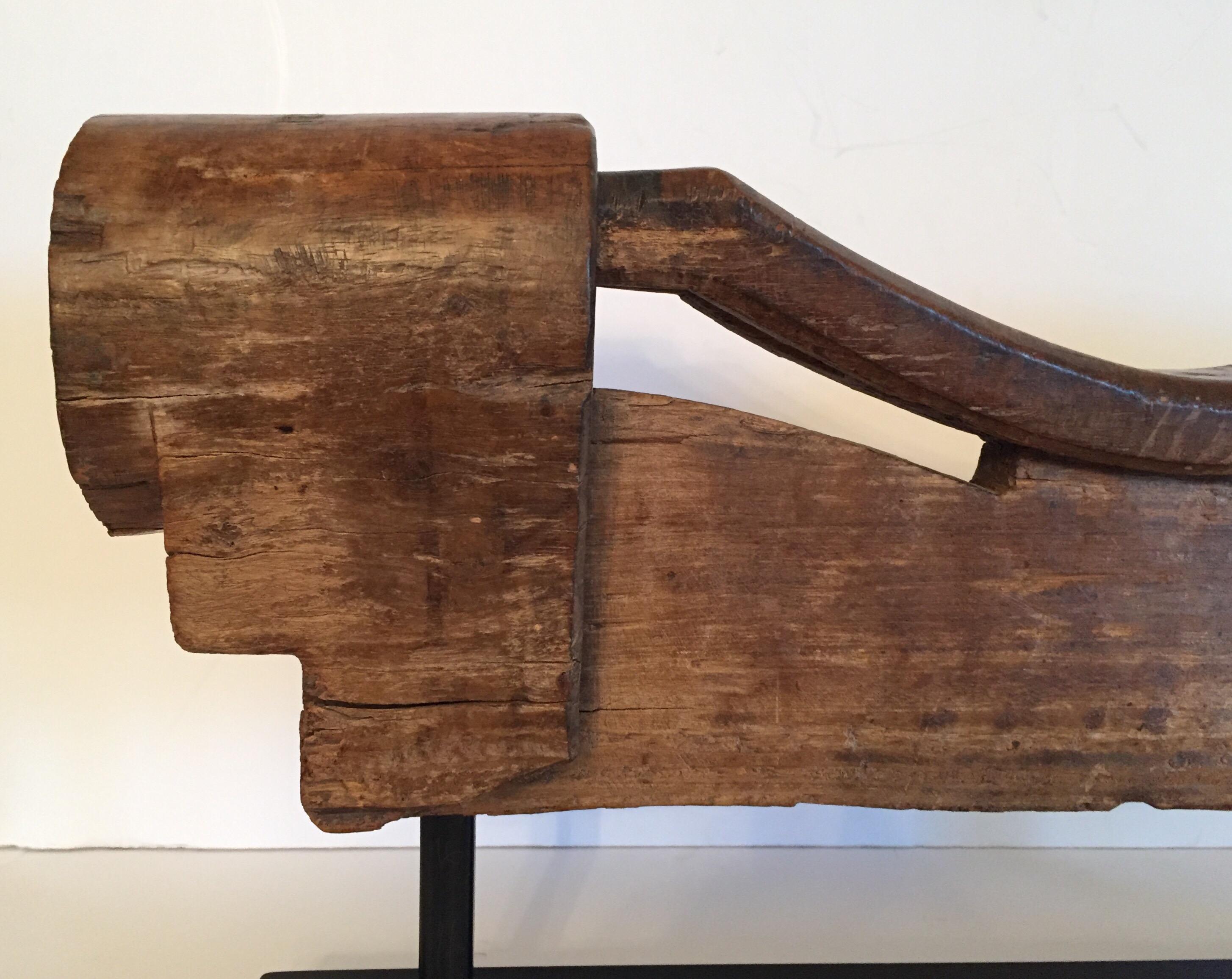 A rustic ox wooden yoke mounted on a custom made black wooden painted stepped base stand. 
In rustic appearance and large proportions this rustic tribal wooden yoke will be a wonderful conversation piece, and will no doubt add a touch of
