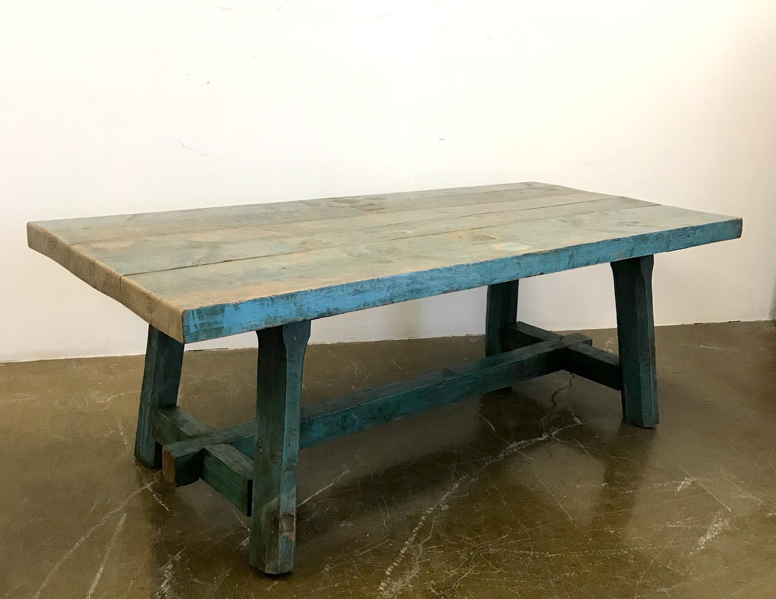 This table has been refashioned from a long skinny console into a fabulous rustic farm table. Original paint throughout. Sturdy construction. The boards are 14.25